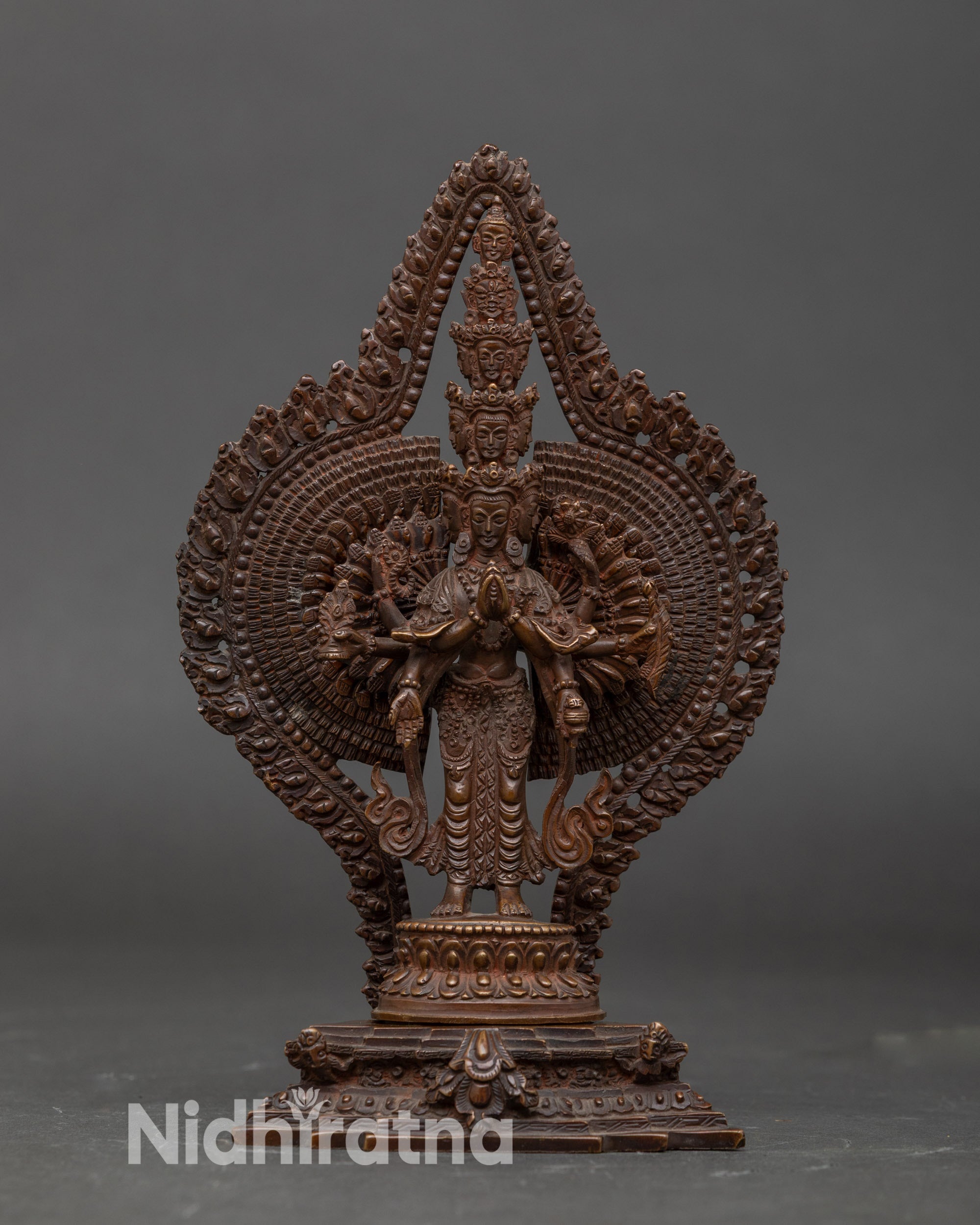 Front view 1000-Armed Chenrezig statue in Nepalese copper with 11 heads and lotus throne