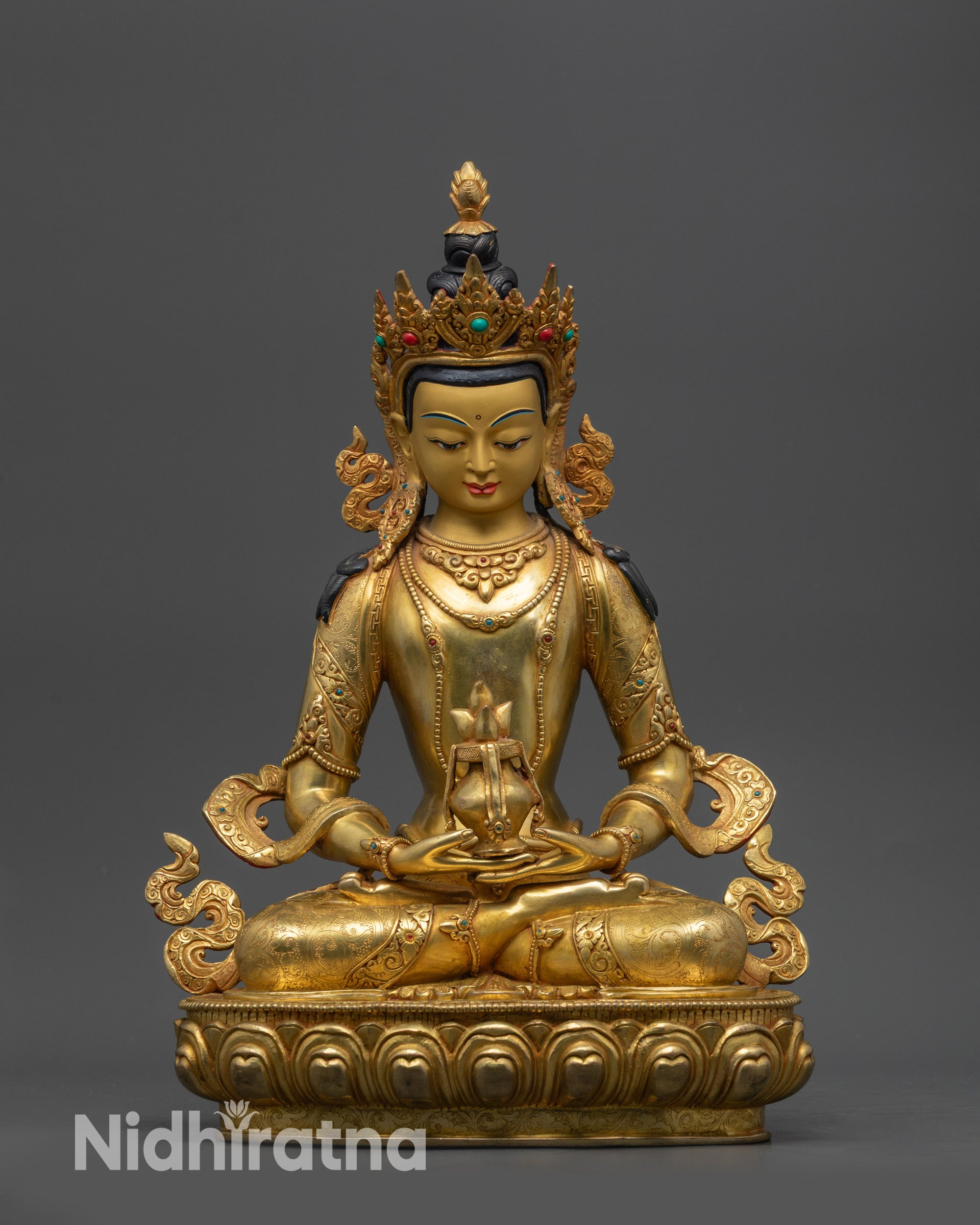 Front view Amitayus statue with gold-gilded face and lotus throne
