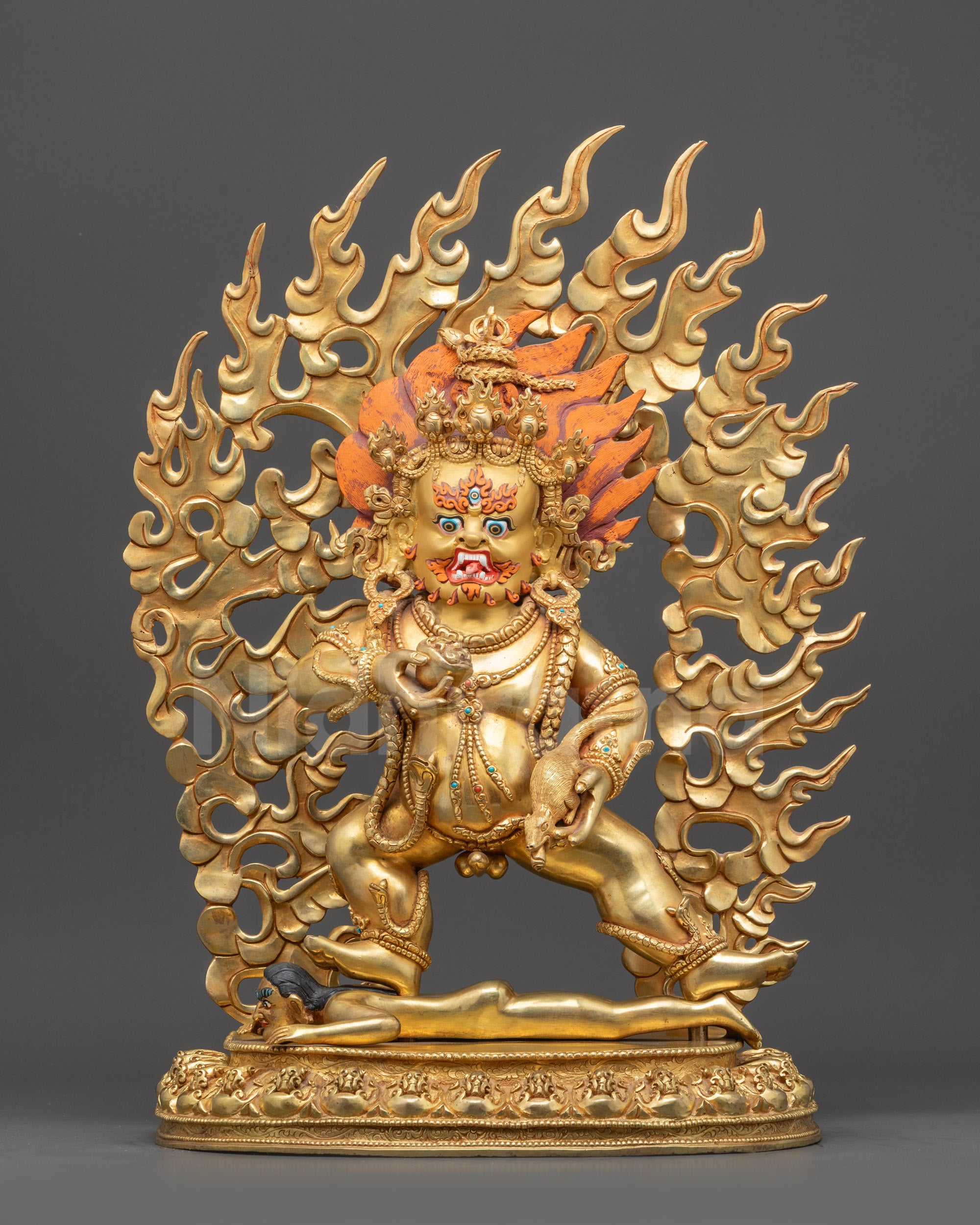 Front view Black Dzambhala statue crushing evil deity on lotus with kapala and mongoose
