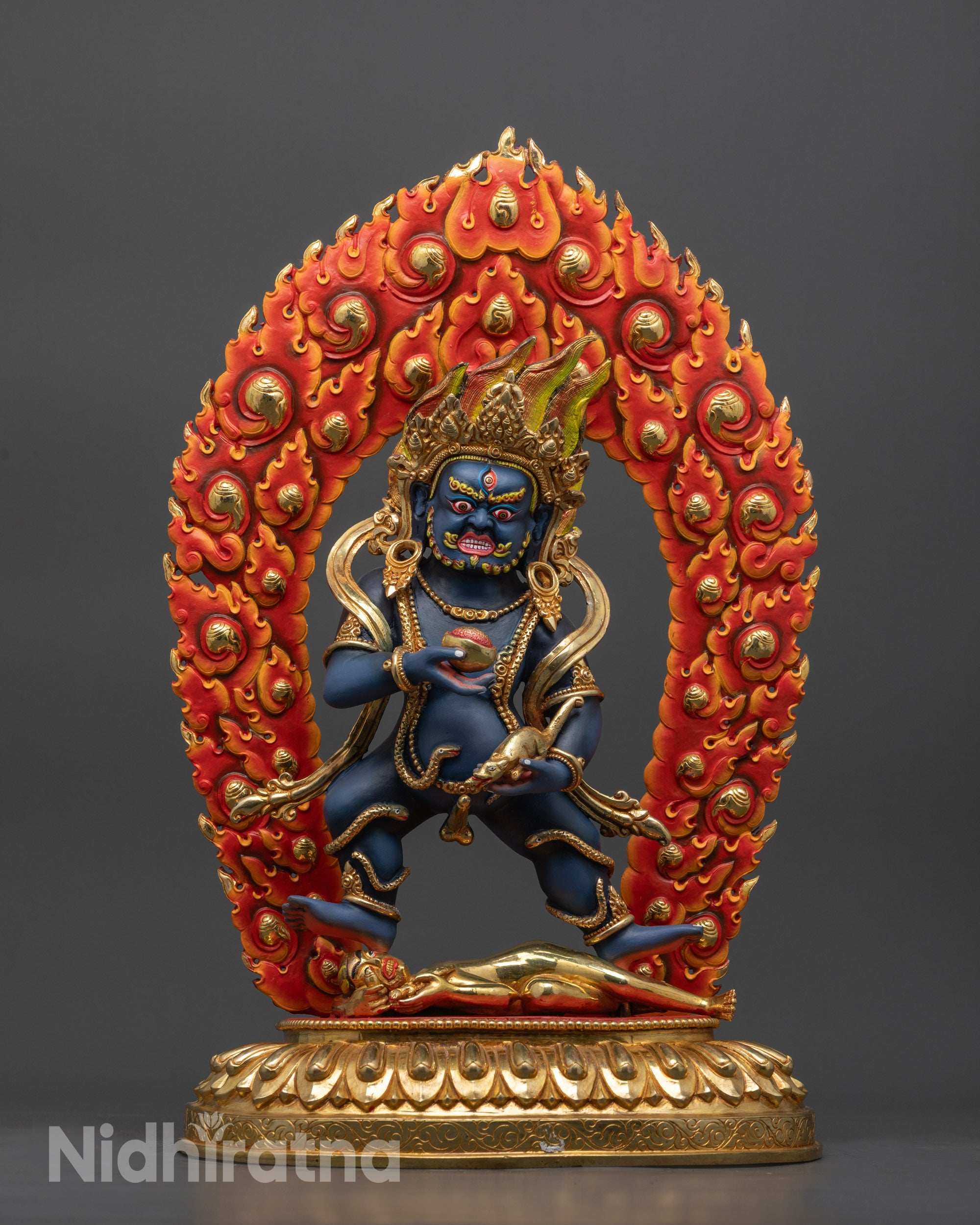 Front view Black Dzambhala statue with gold crown and lotus base, wrathful deity pose