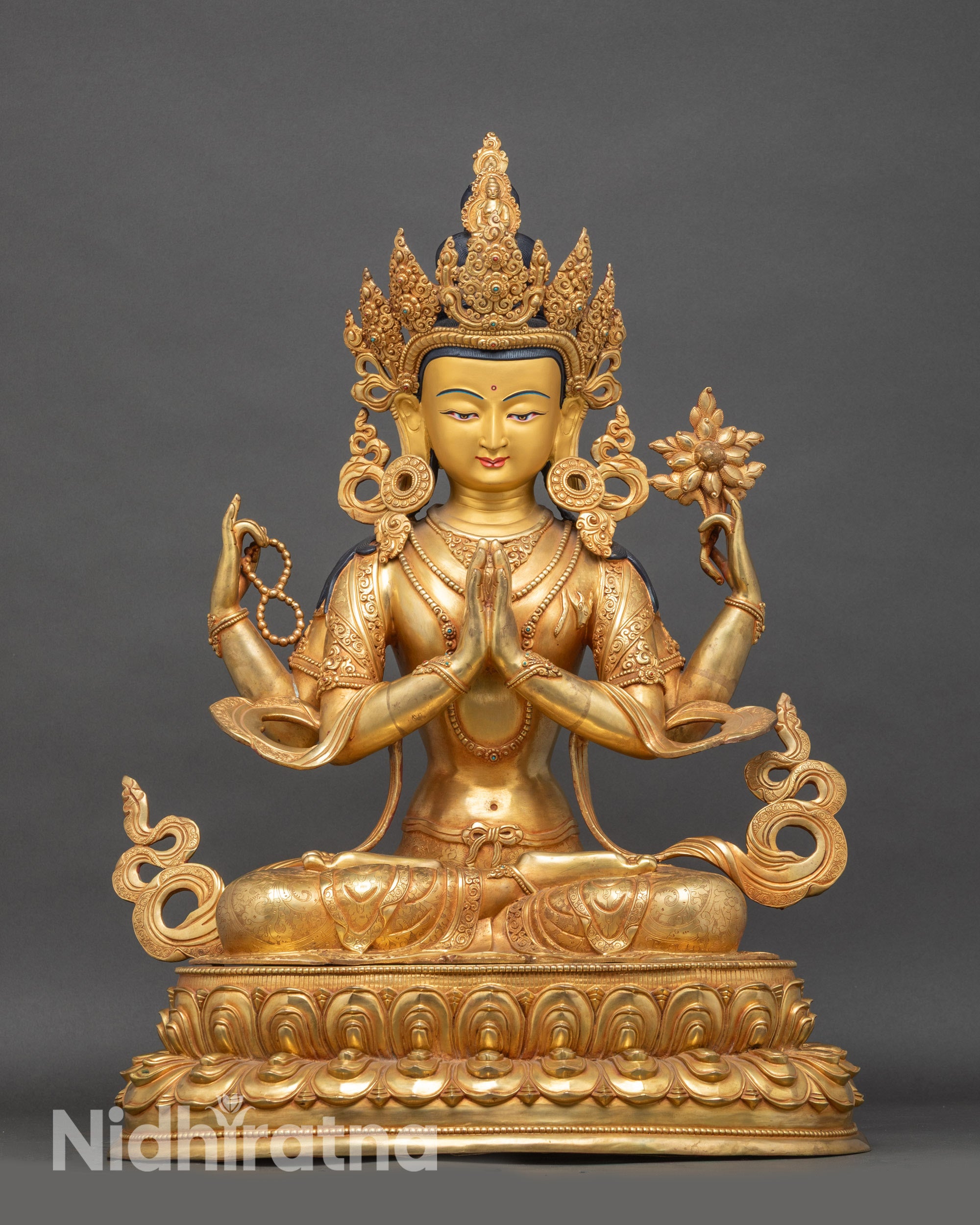 Front view Chenrezig statue, copper with gold accents and lotus pedestal details