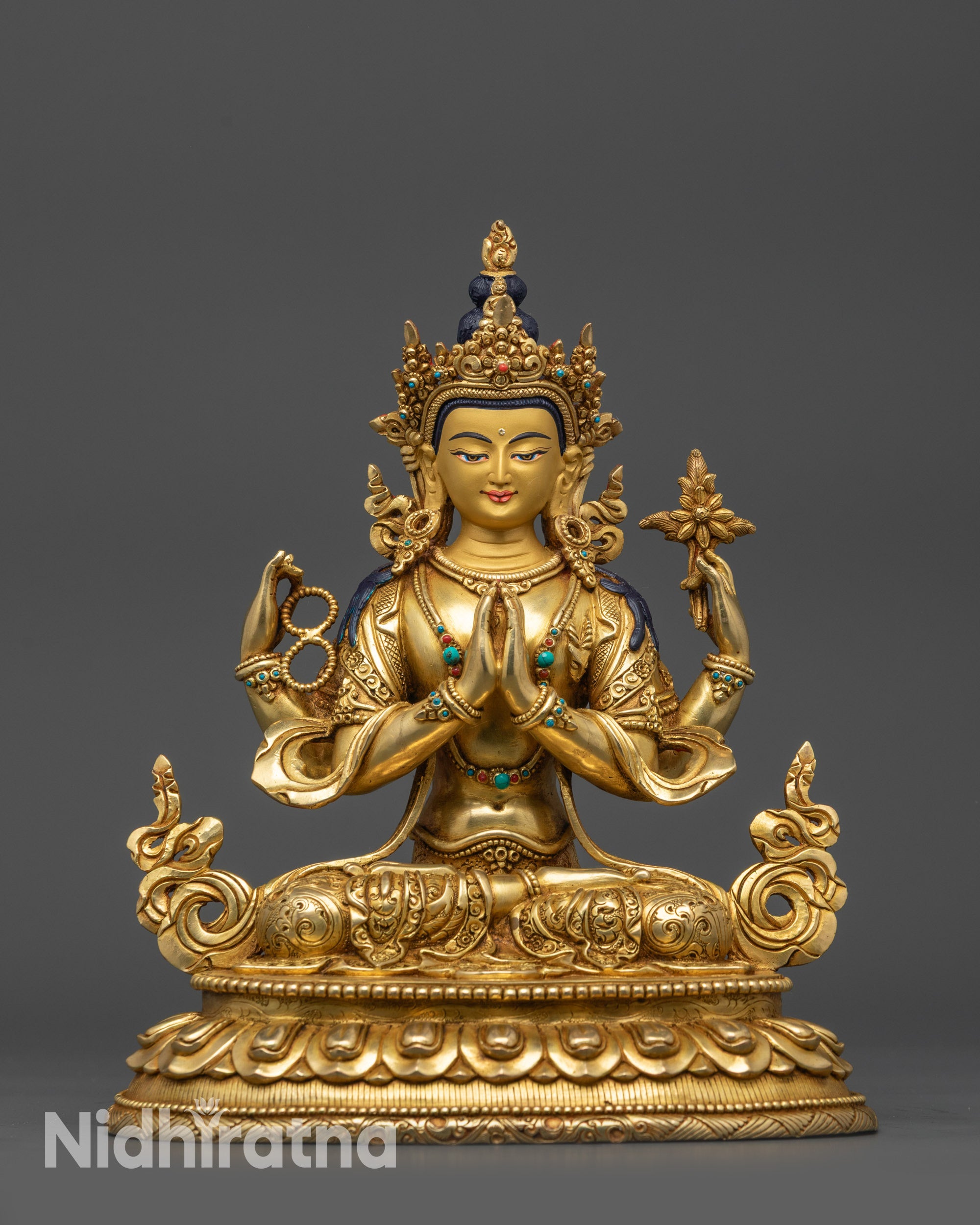 Front view Chenrezig statue with gold-gilded face and lotus seat