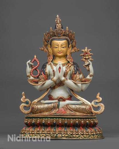 Front view Chenrezig statue with gold-gilded face and white body on lotus base