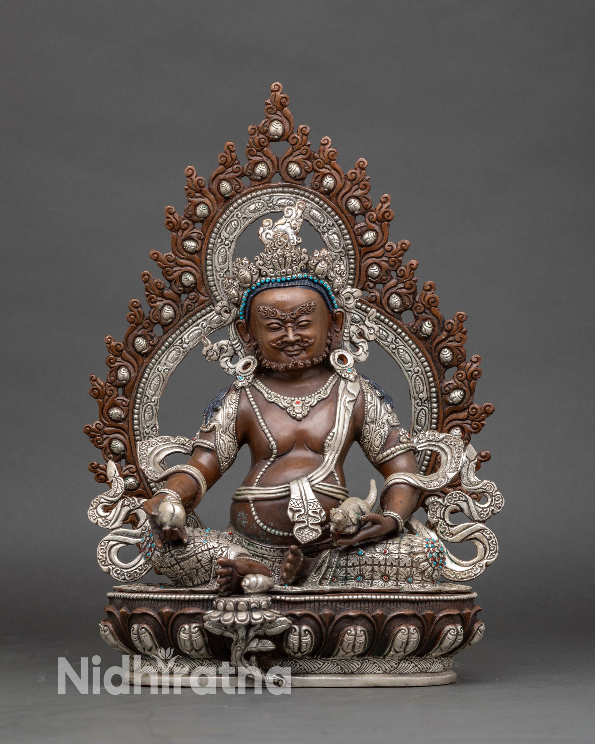 Front view Dzambhala statue in oxidized silver-plated copper with halo, lotus seat, citron and mongoose