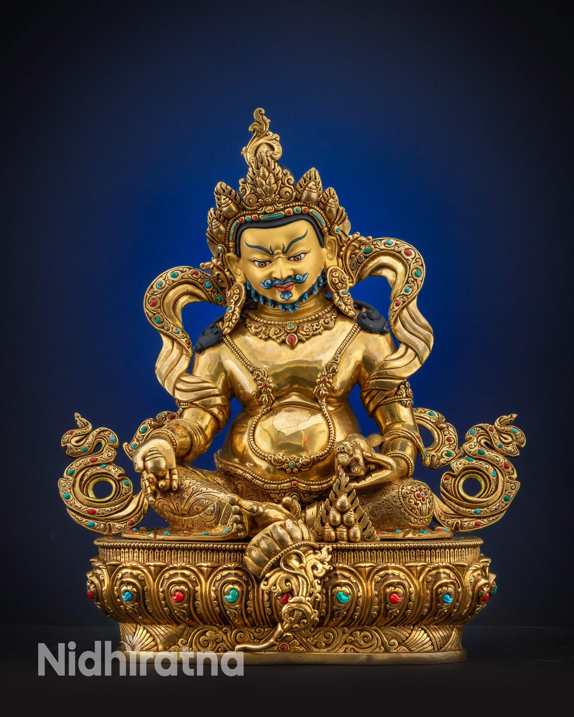 Full view Dzambhala statue showing gold-gilded face, fire-gilded body, and seated on lotus pedestal