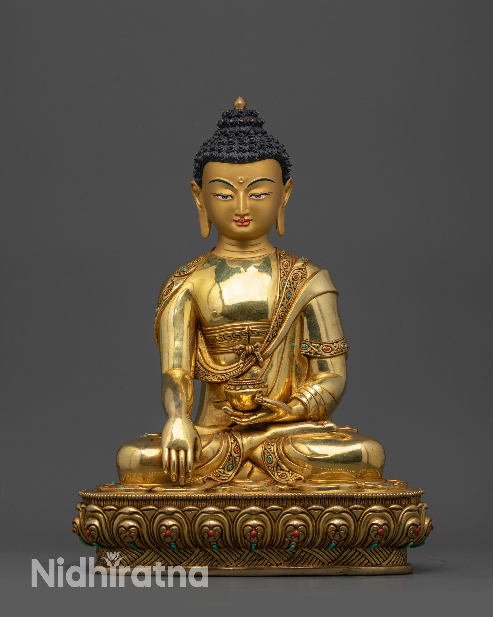 Front view Golden Shakyamuni Buddha statue on lotus base in meditation pose
