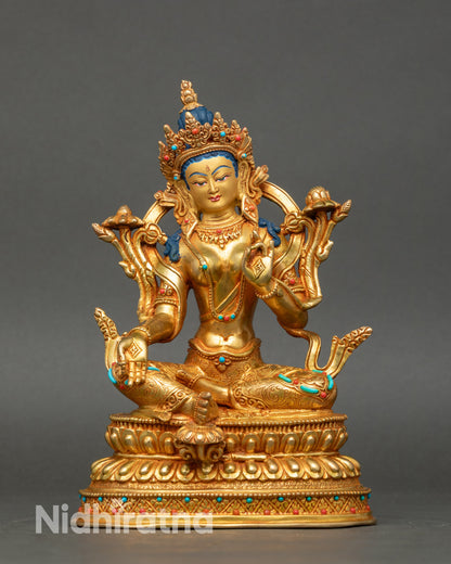 Front view Green Tara statue, gold with coral and turquoise, seated on double lotus seat Nepal