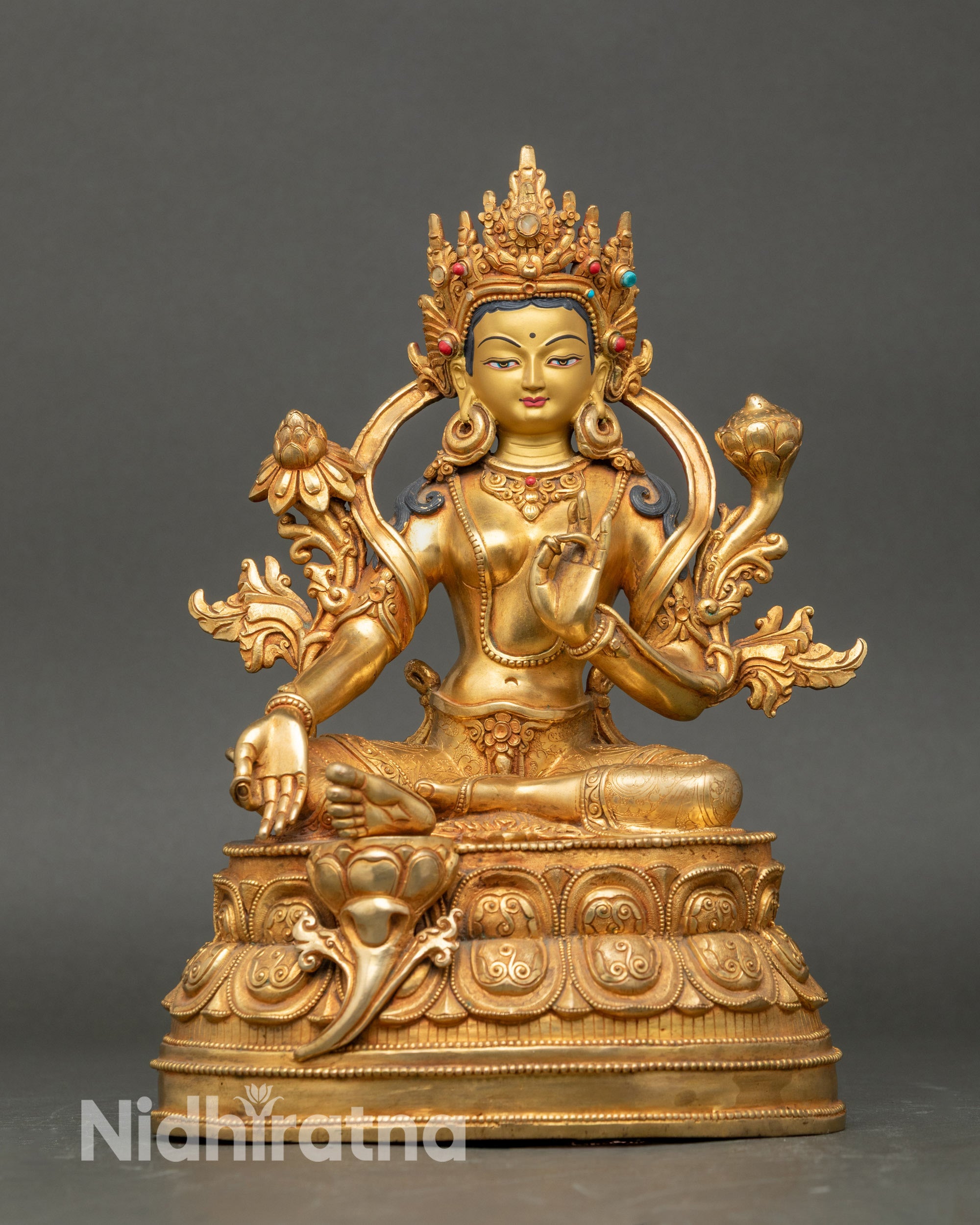 Front view Green Tara statue, gold with coral and turquoise, seated on double lotus throne Nepal
