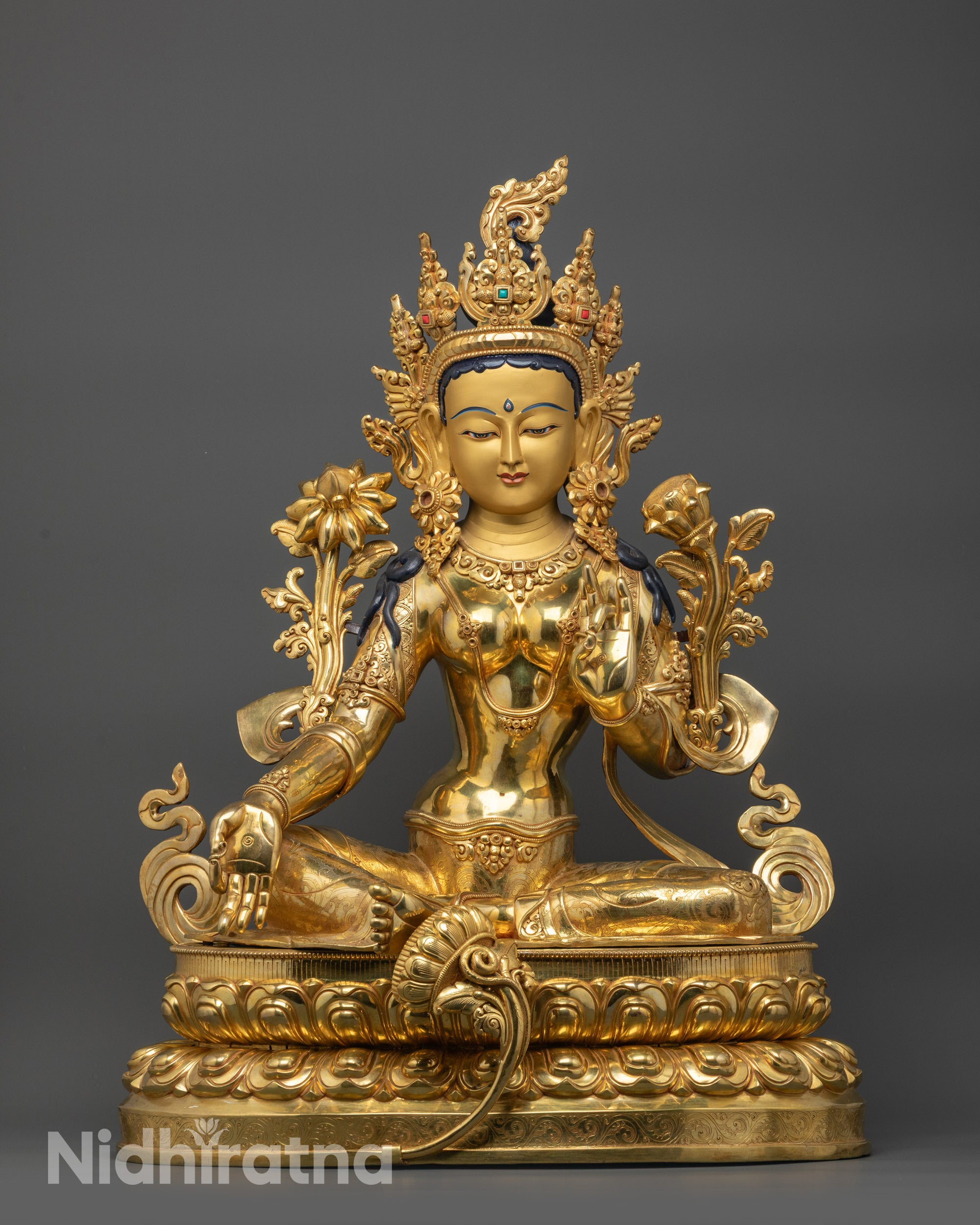 Front view Green Tara statue with gold gilded face, fire-gilded body, and lotus base