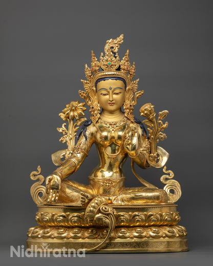 Front view Green Tara statue with gold gilded face, fire-gilded body, and lotus base