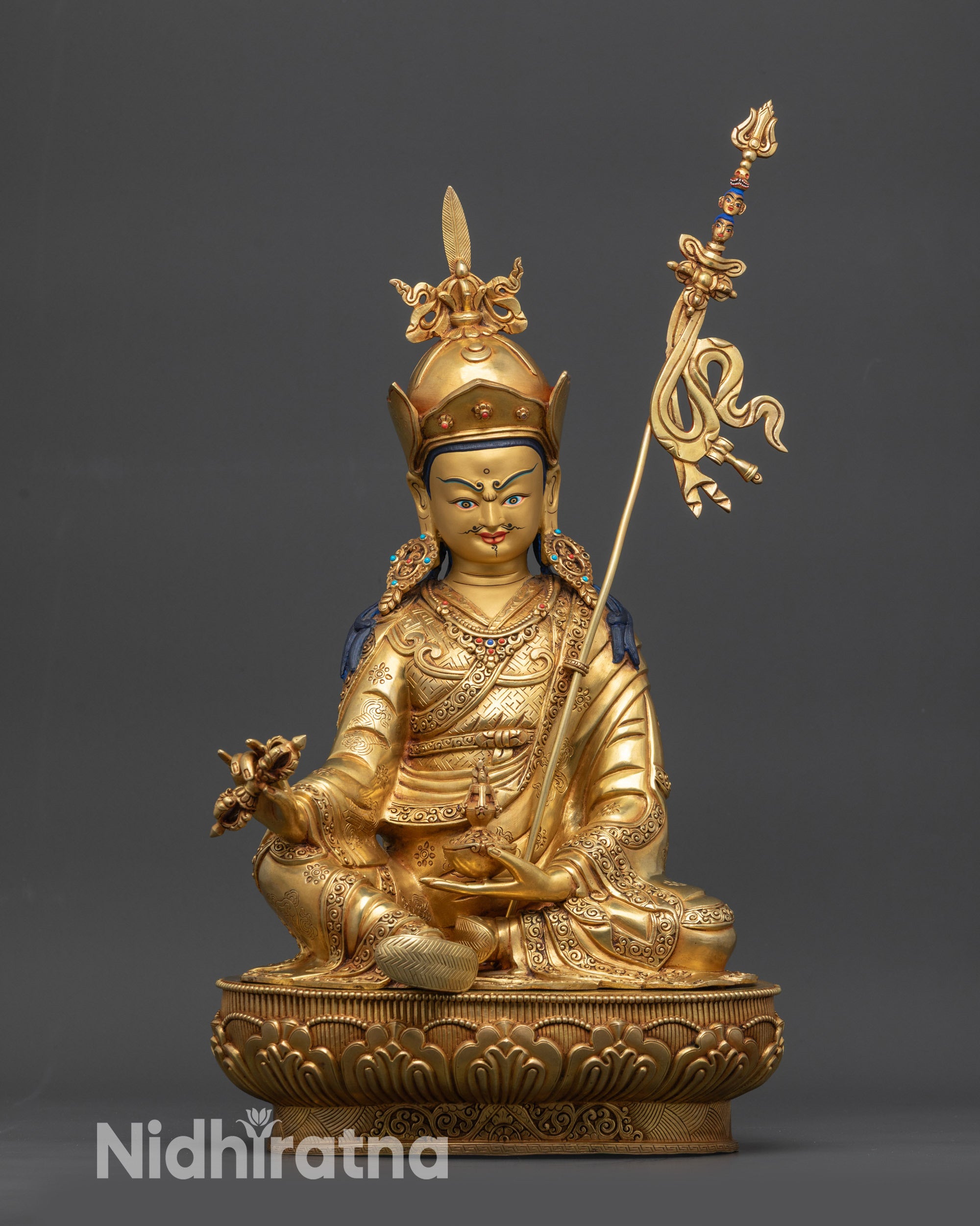 Front view Guru Rinpoche statue on lotus base with gold fire-gilded face
