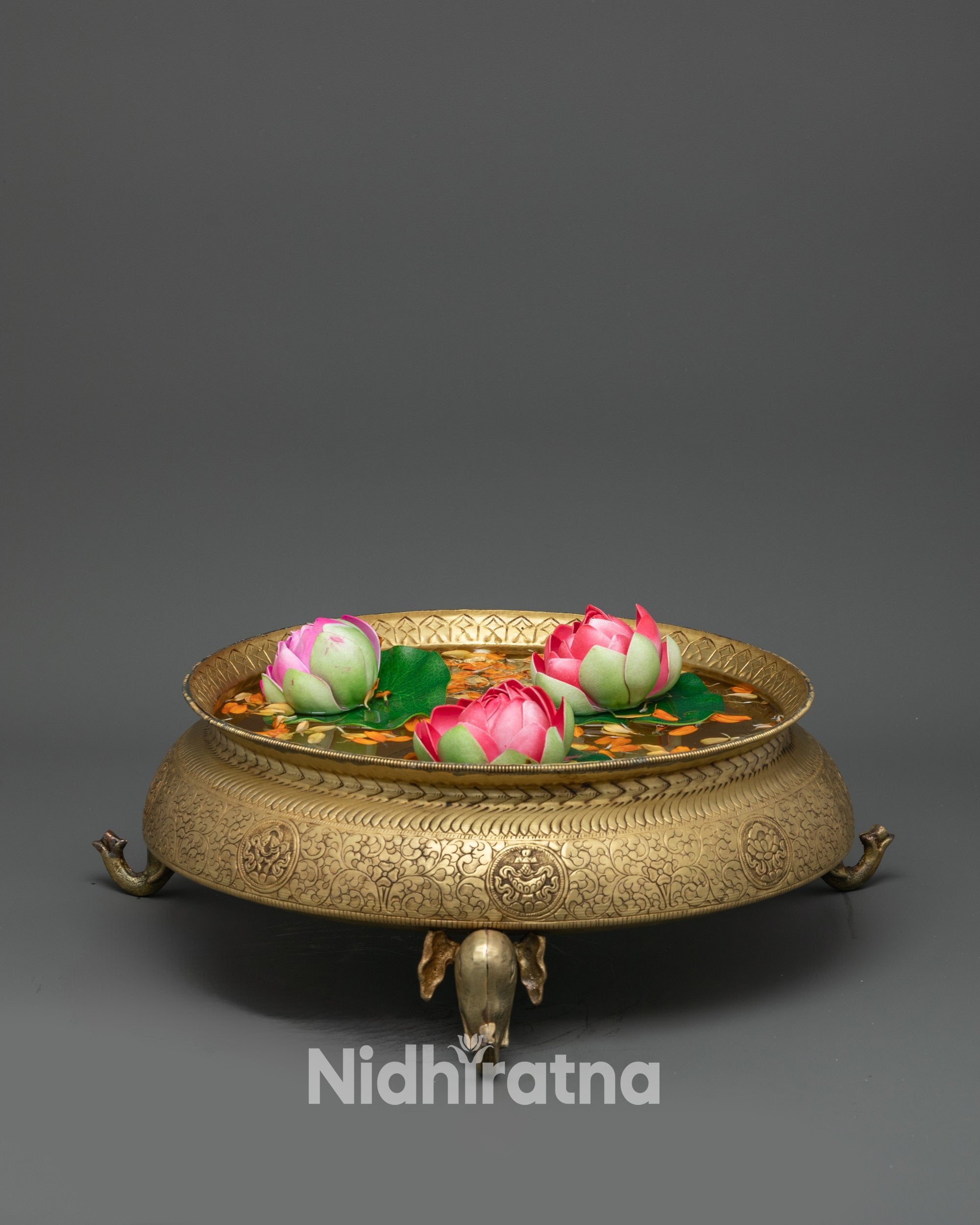 Front view Handcrafted Tibetan Urli Bowl on elephant-head base, copper ritual vessel