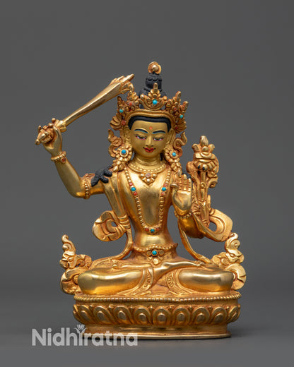Front view Himalayan Manjushri Statue with gold-gilded face and crown
