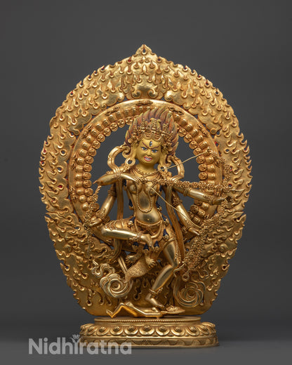 Front view Kurukulla statue with gold-gilded face and fire-gilded body standing on figure
