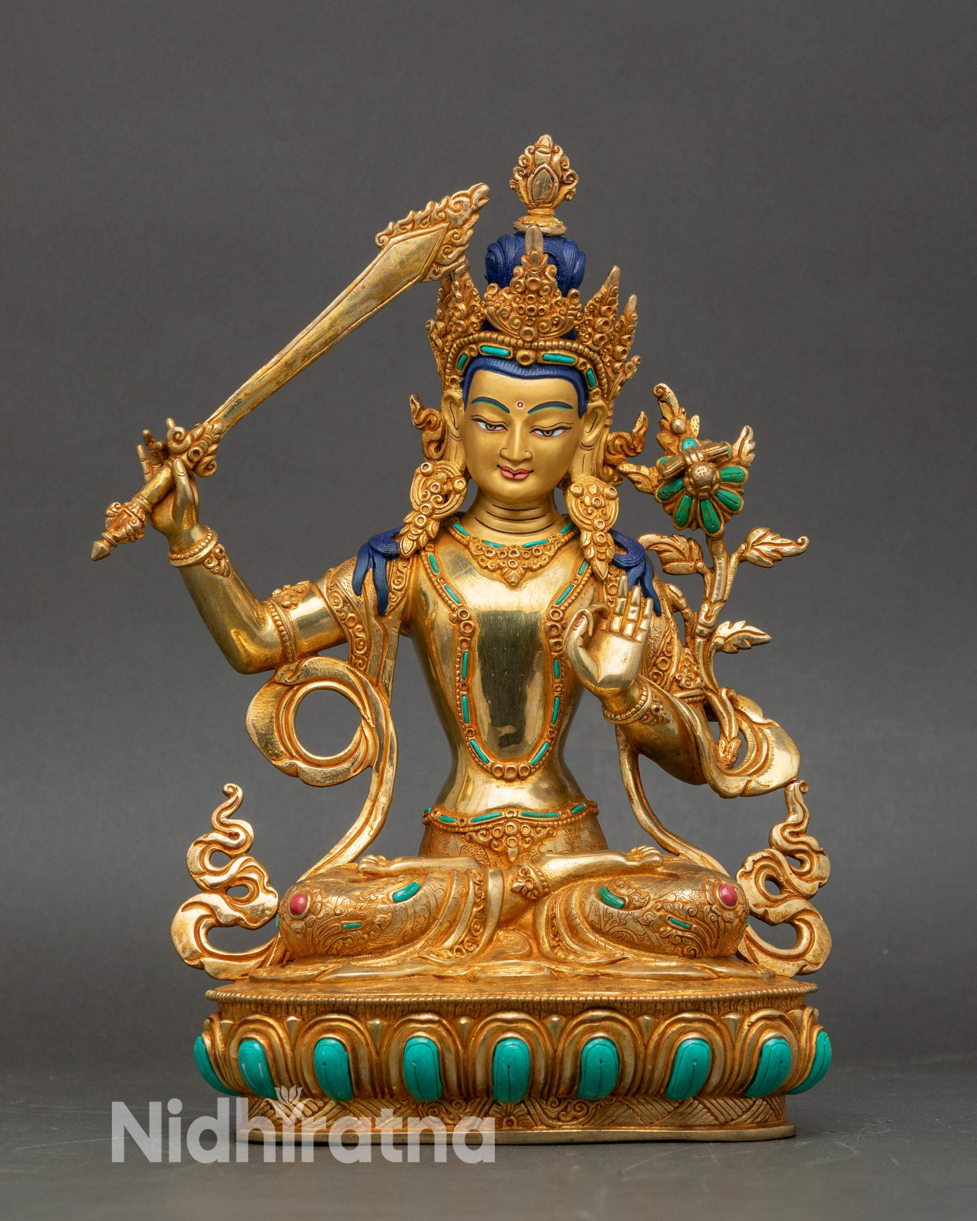 Front view Manjushree statue, copper gilded, seated on lotus throne, sword and scripture