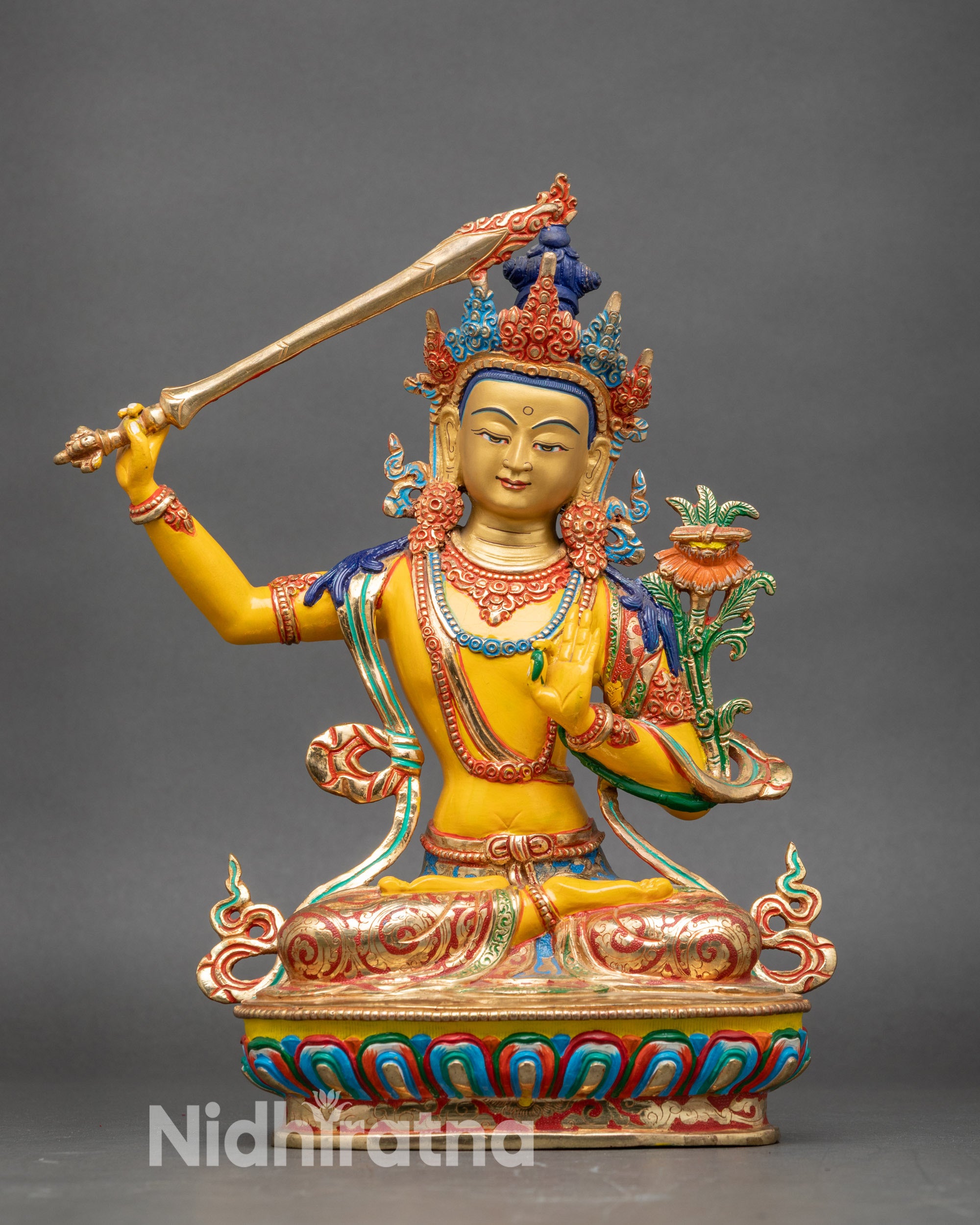 Front view Manjushree statue copper with yellow-hued acrylic and gold-gilded face