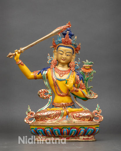 Front view Manjushree statue copper with yellow-hued acrylic and gold-gilded face
