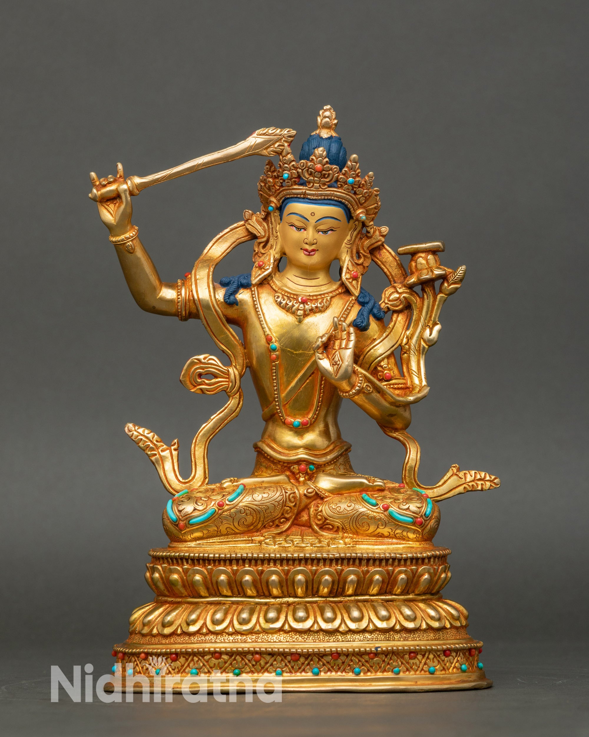 Front view Manjushree statue handmade in Nepal, gold-detailed copper with flaming sword
