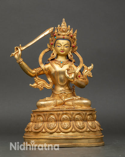Front view Manjushree statue seated on double lotus, gold Buddhist wisdom deity from Nepal