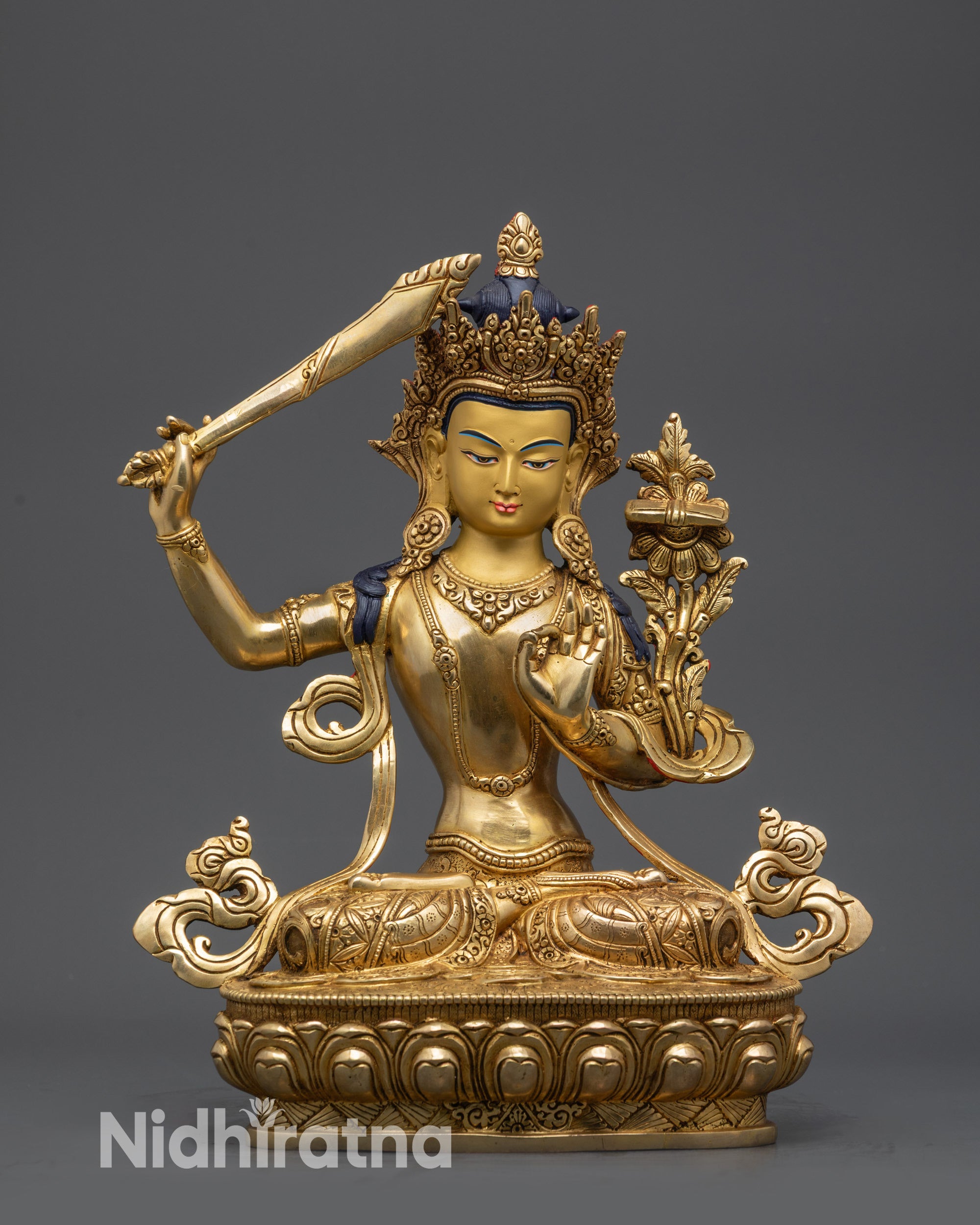 Front view Manjushri Statue on lotus throne with gold-gilded face and intricate robes
