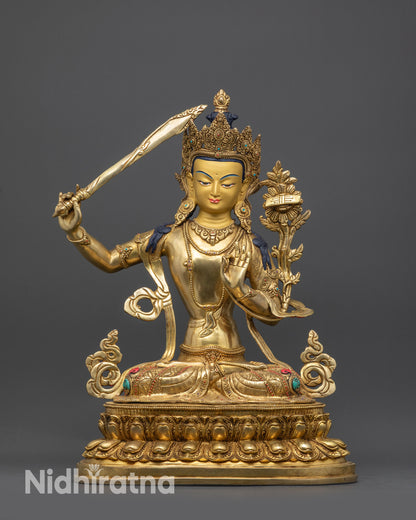 Front view Manjushri statue on lotus with gold fire-gilded face and robes
