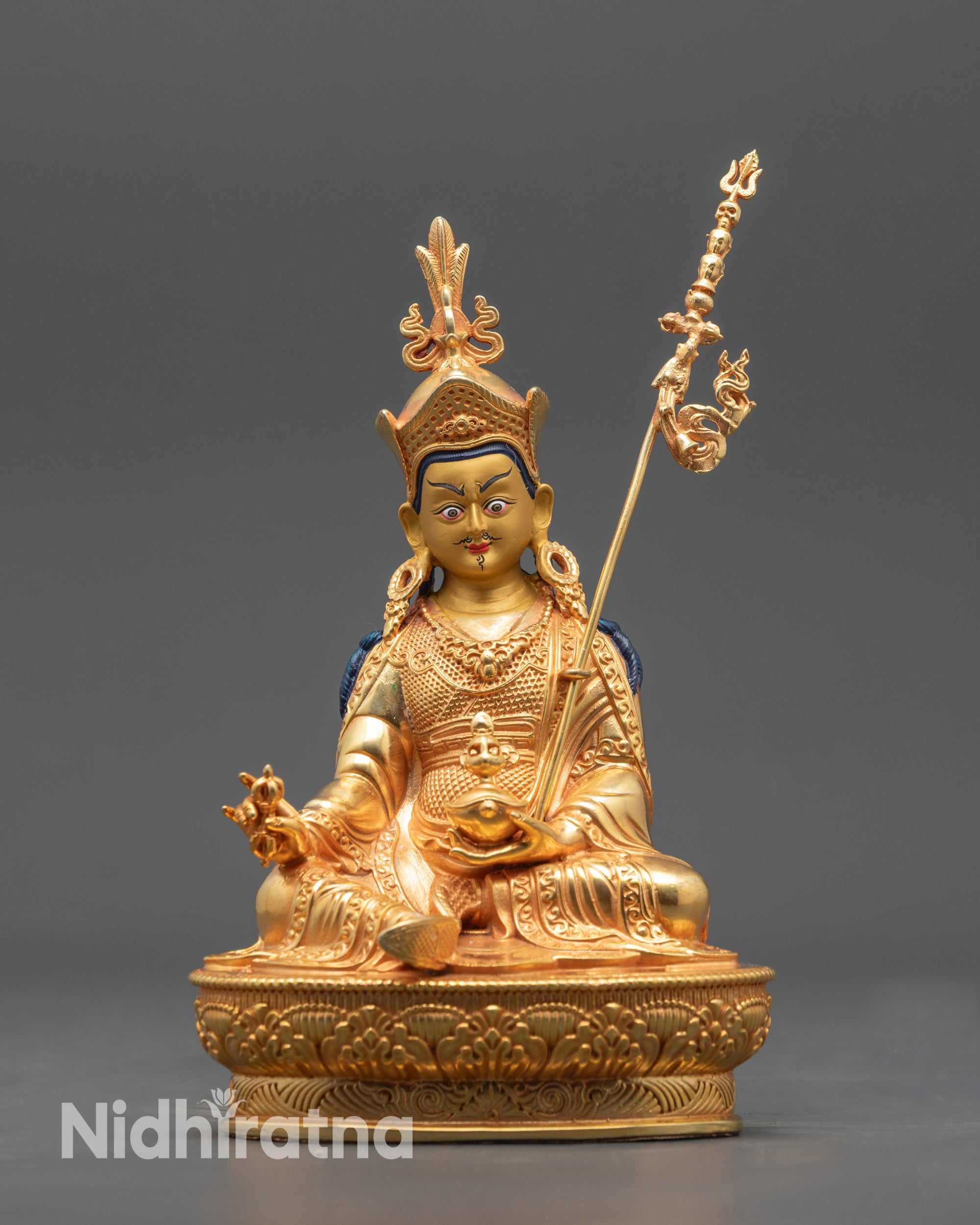 Front view Nepalese Guru Rinpoche statue with gold-gilded face and lotus seat
