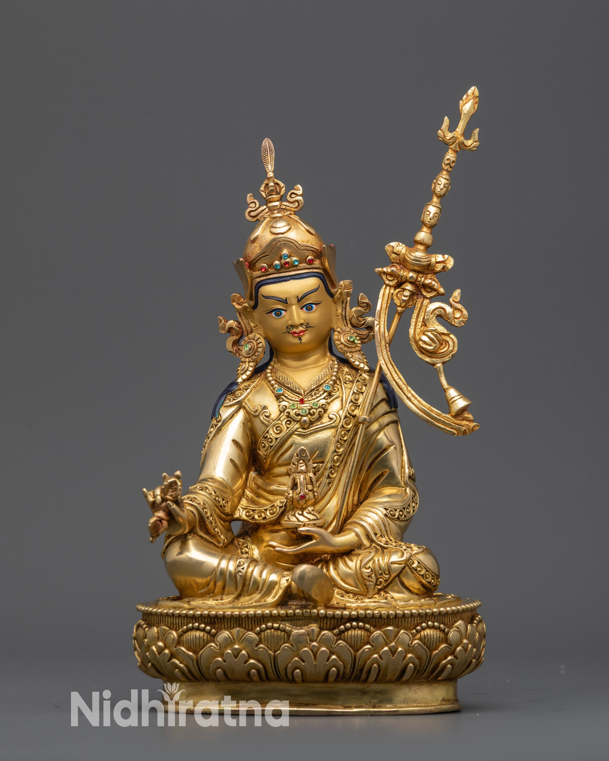 Front view Padmasambhava Guru Rinpoche statue with gold-gilded face and lotus seat
