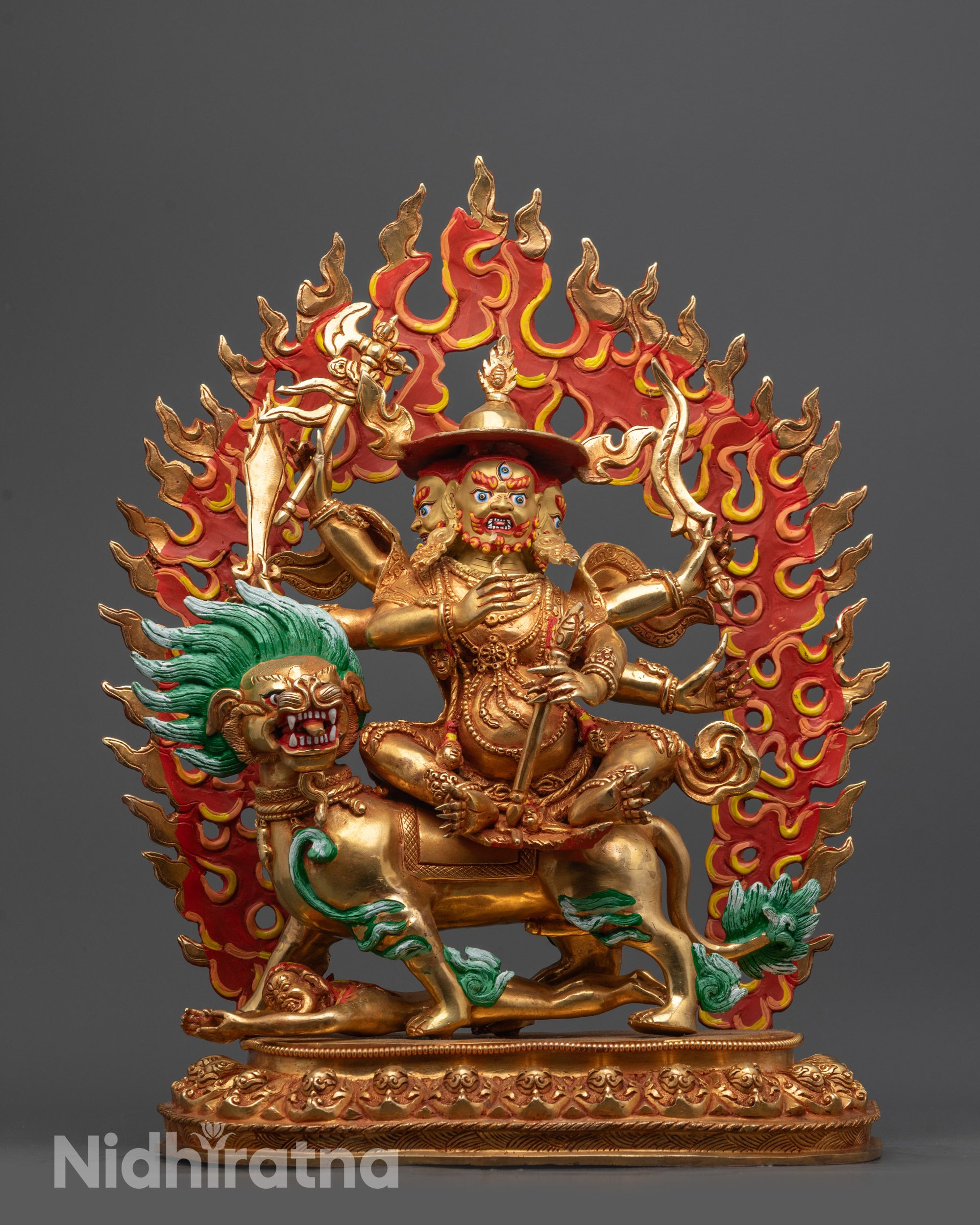 Front view Pehar Gyalpo statue with gold fire-gilded body and three heads on snow lion
