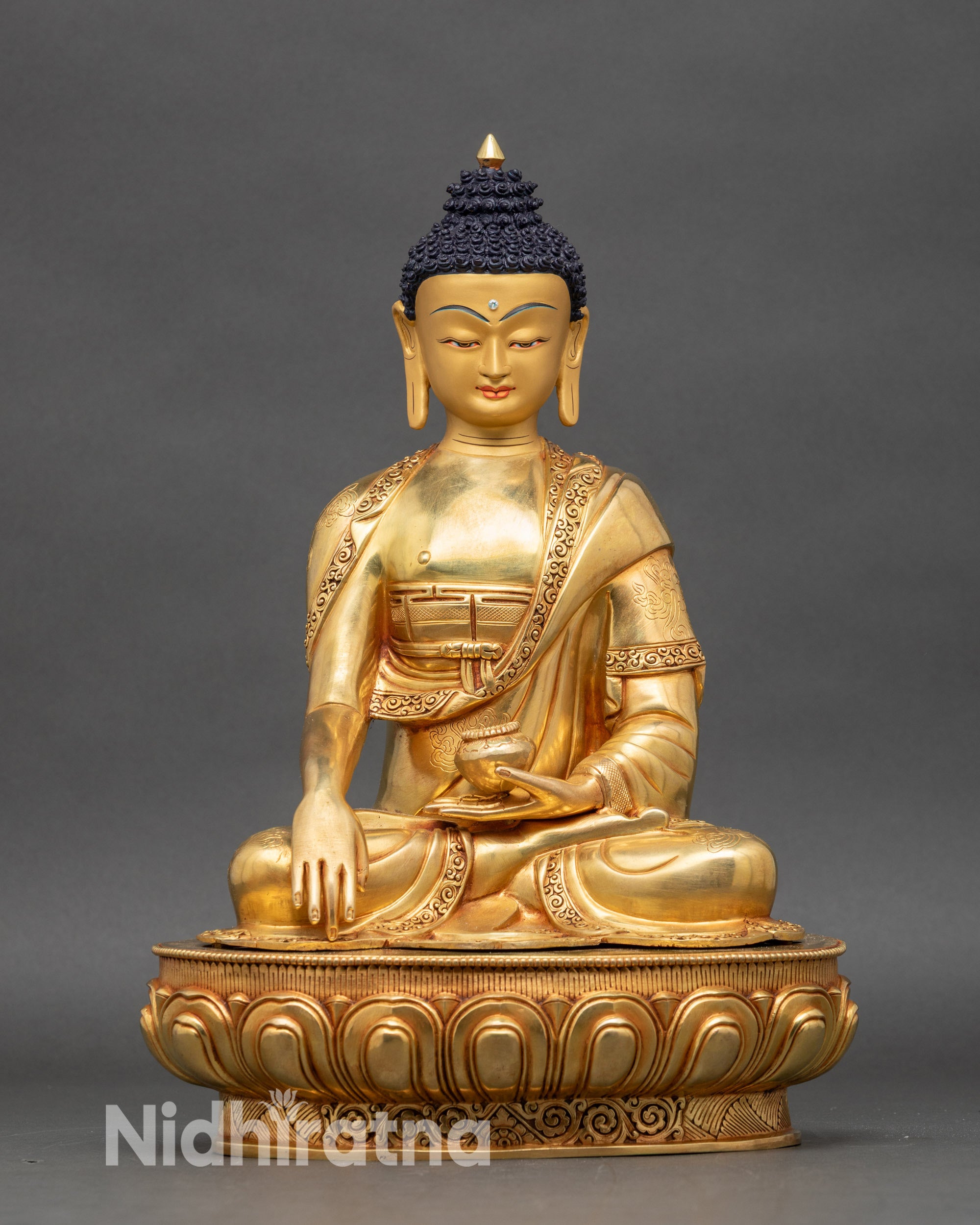 Front view Shakyamuni Buddha statue copper gold painted face lotus pedestal earth touching mudra Nepal