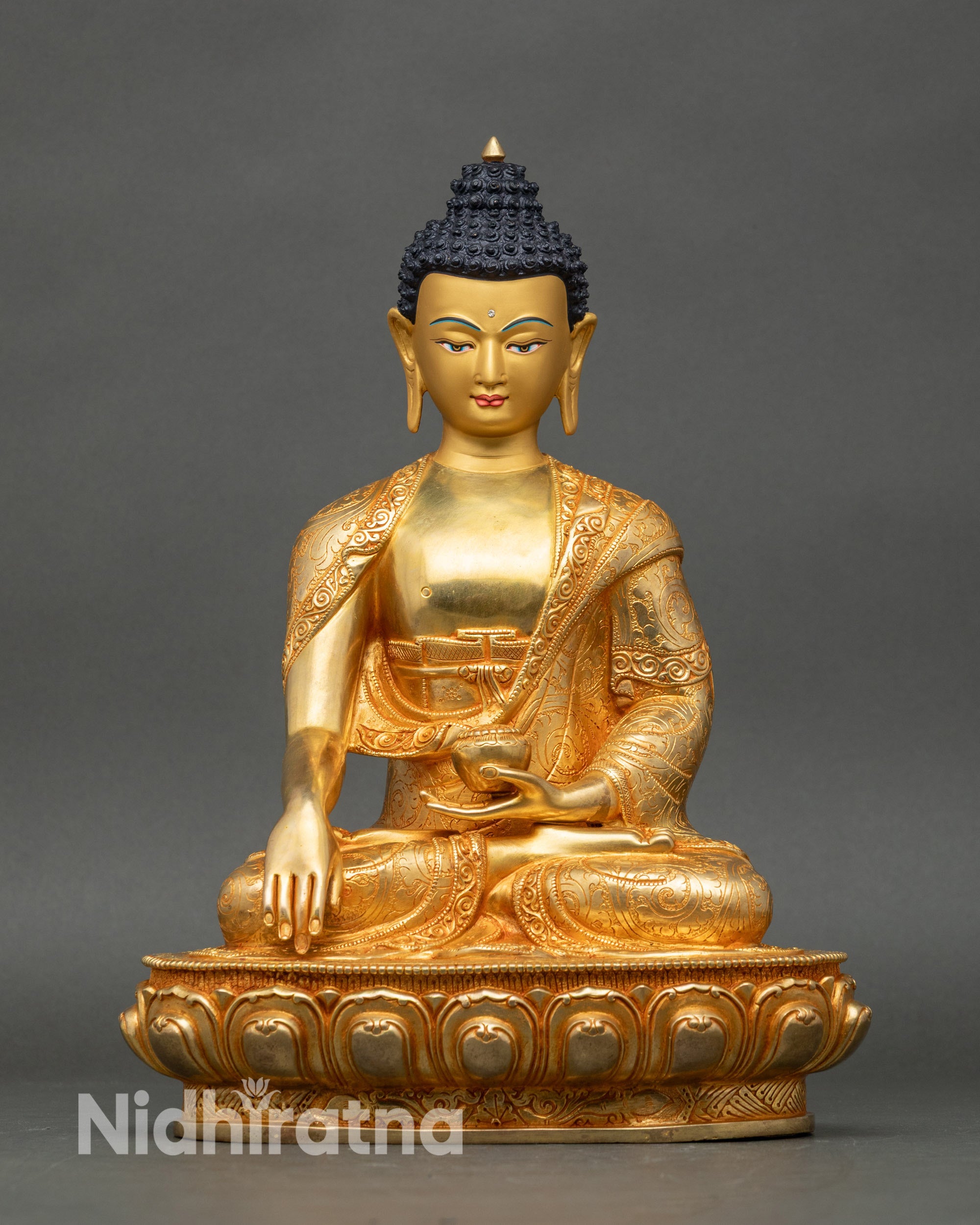 Front view Shakyamuni Buddha statue with lotus seat, patra bowl, and tranquil expression