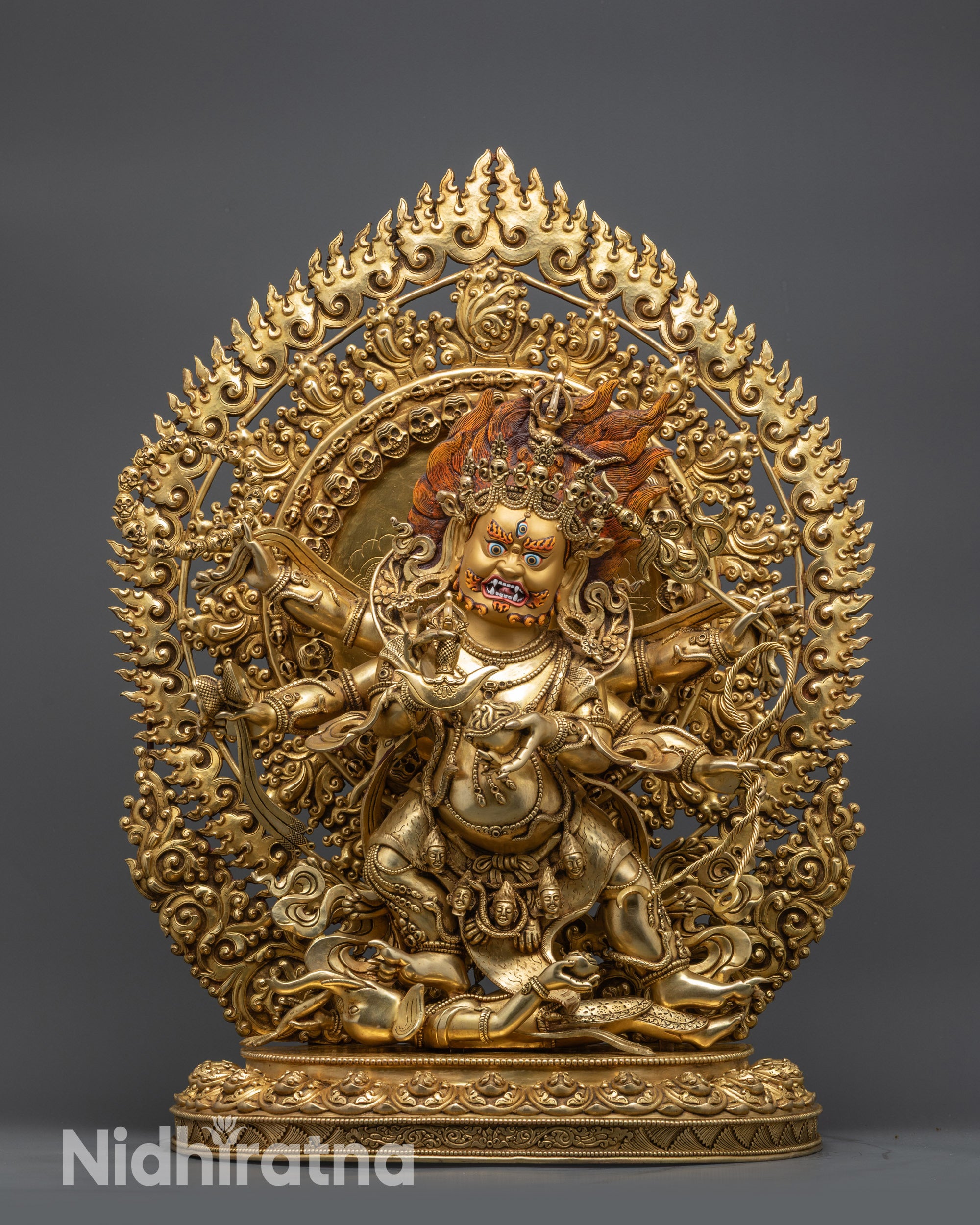 Front view Six-Armed Mahakala statue with gold-gilded face on lotus seat