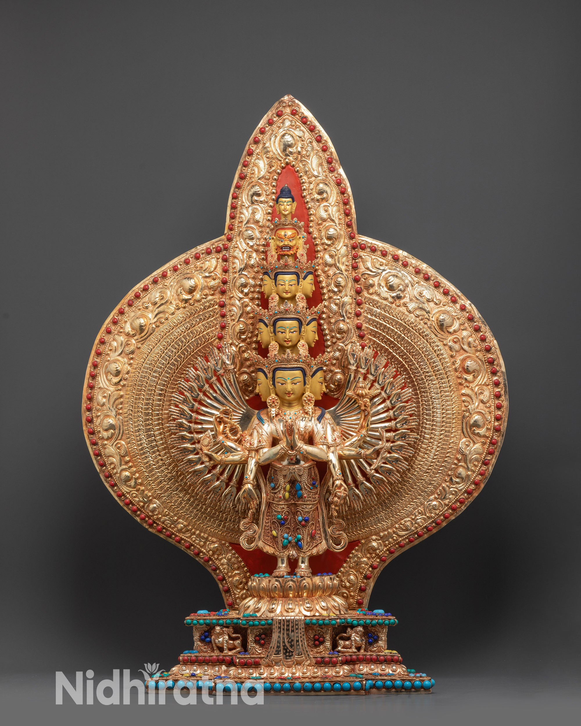 Front view Thousand-Armed Chenrezig Statue with 24K gold faces on lotus seat
