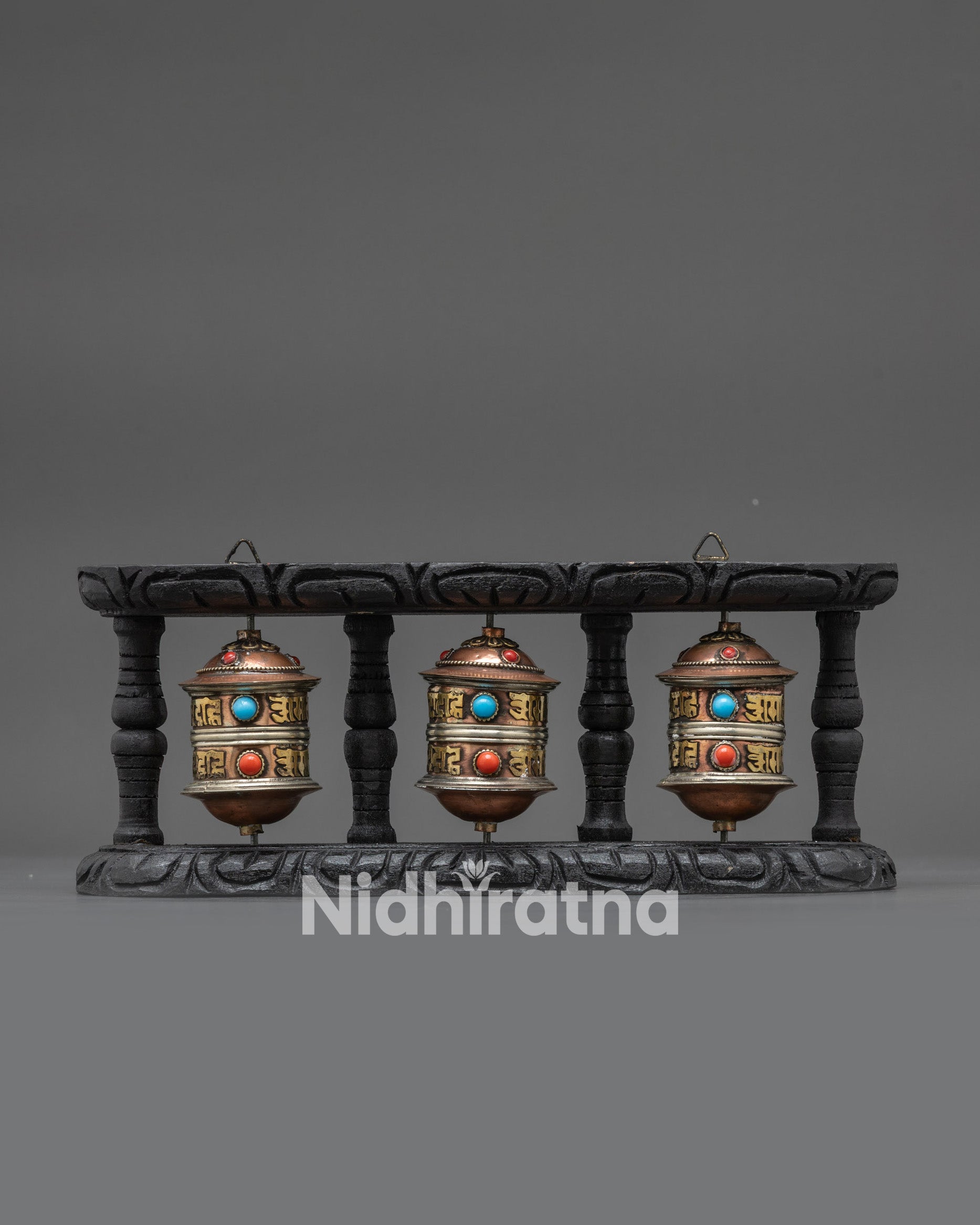 Front view Tibetan Triple Prayer Wheel Set with dark wooden frame and copper brass wheels