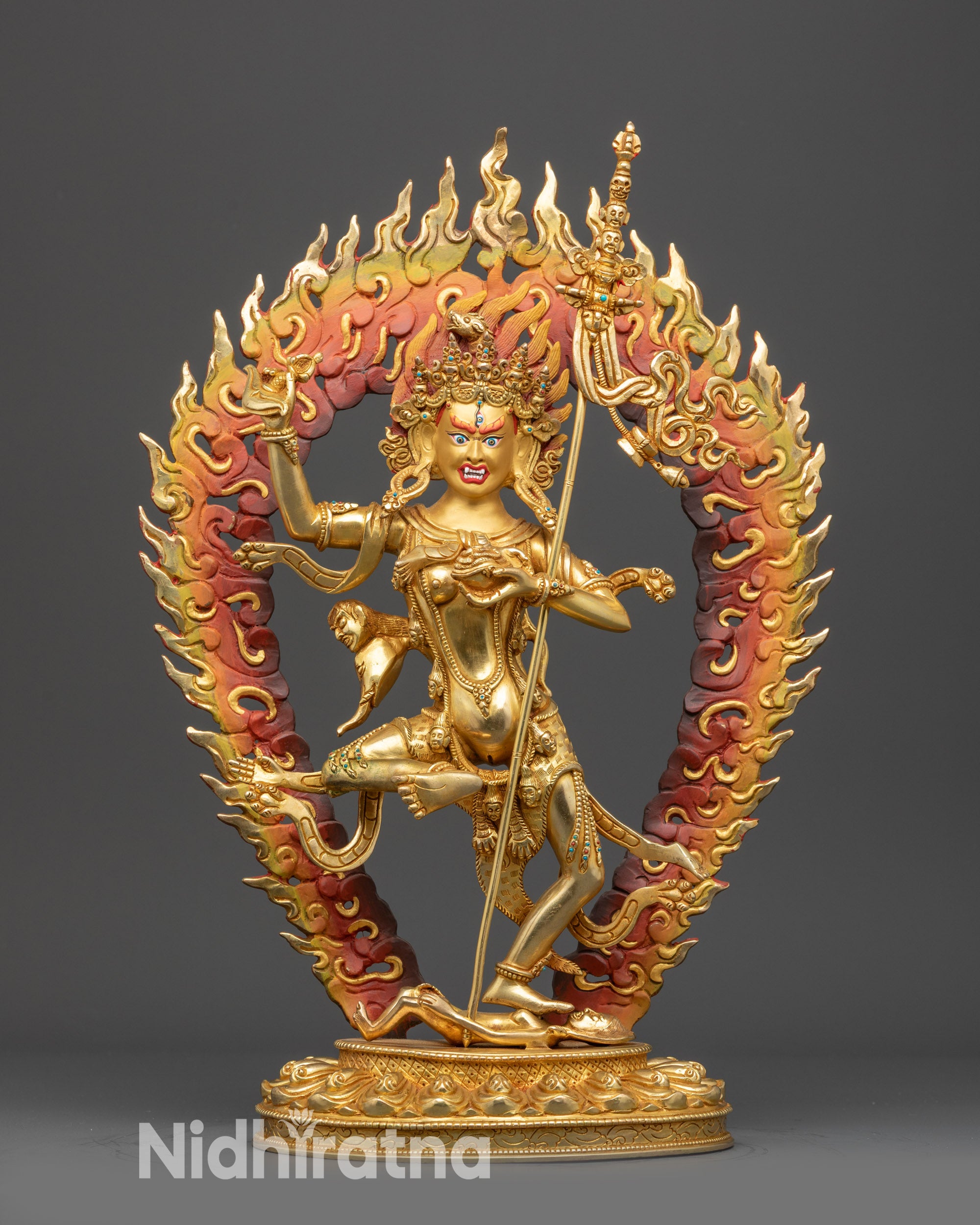 Front view Troma Nangmo Statue with gold-gilded face, wrathful expression, and lotus seat
