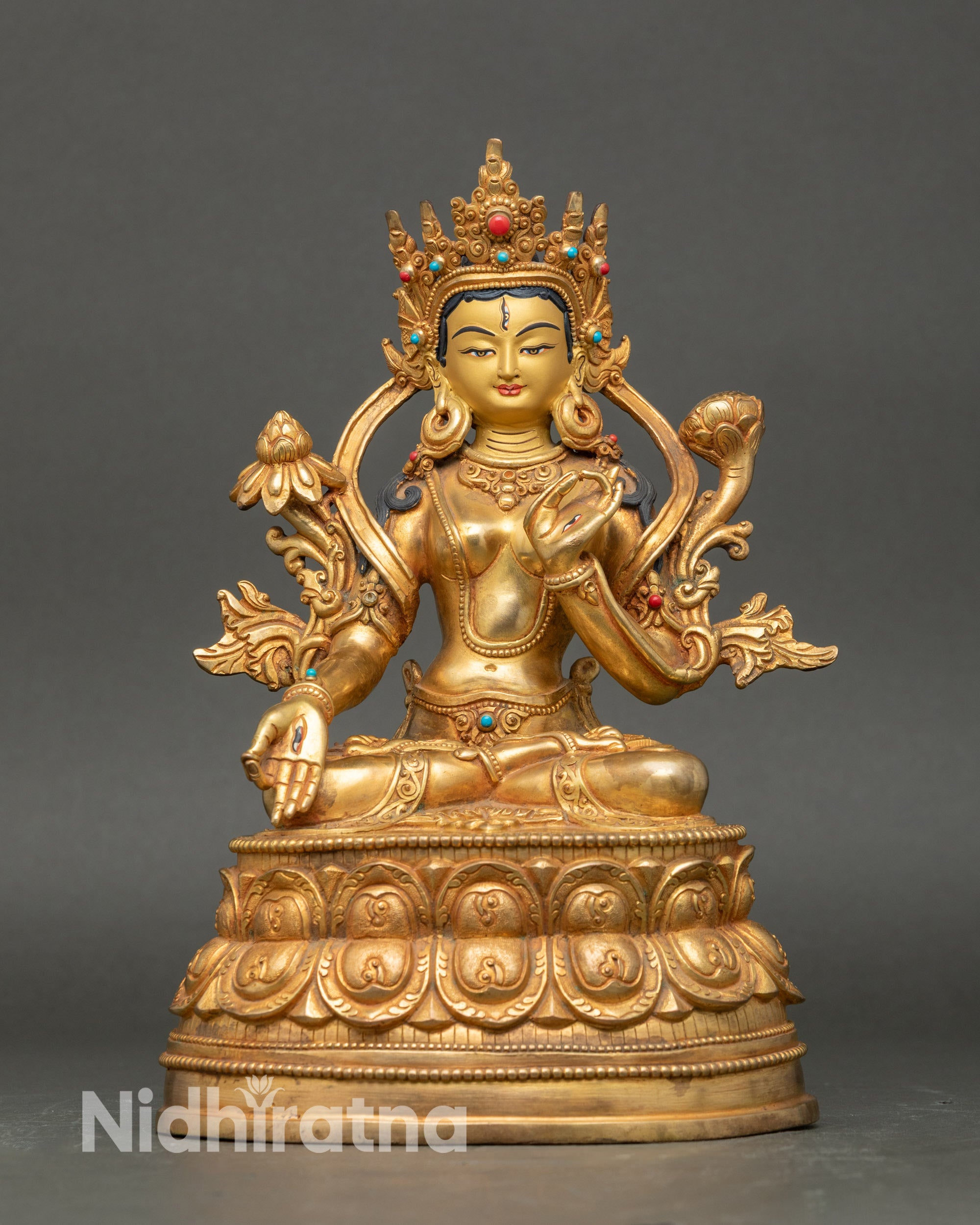 Front view White Tara statue, gold with semi-precious stones, seated on double lotus pedestal