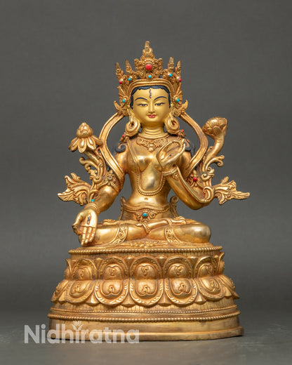 Front view White Tara statue, gold with semi-precious stones, seated on double lotus pedestal