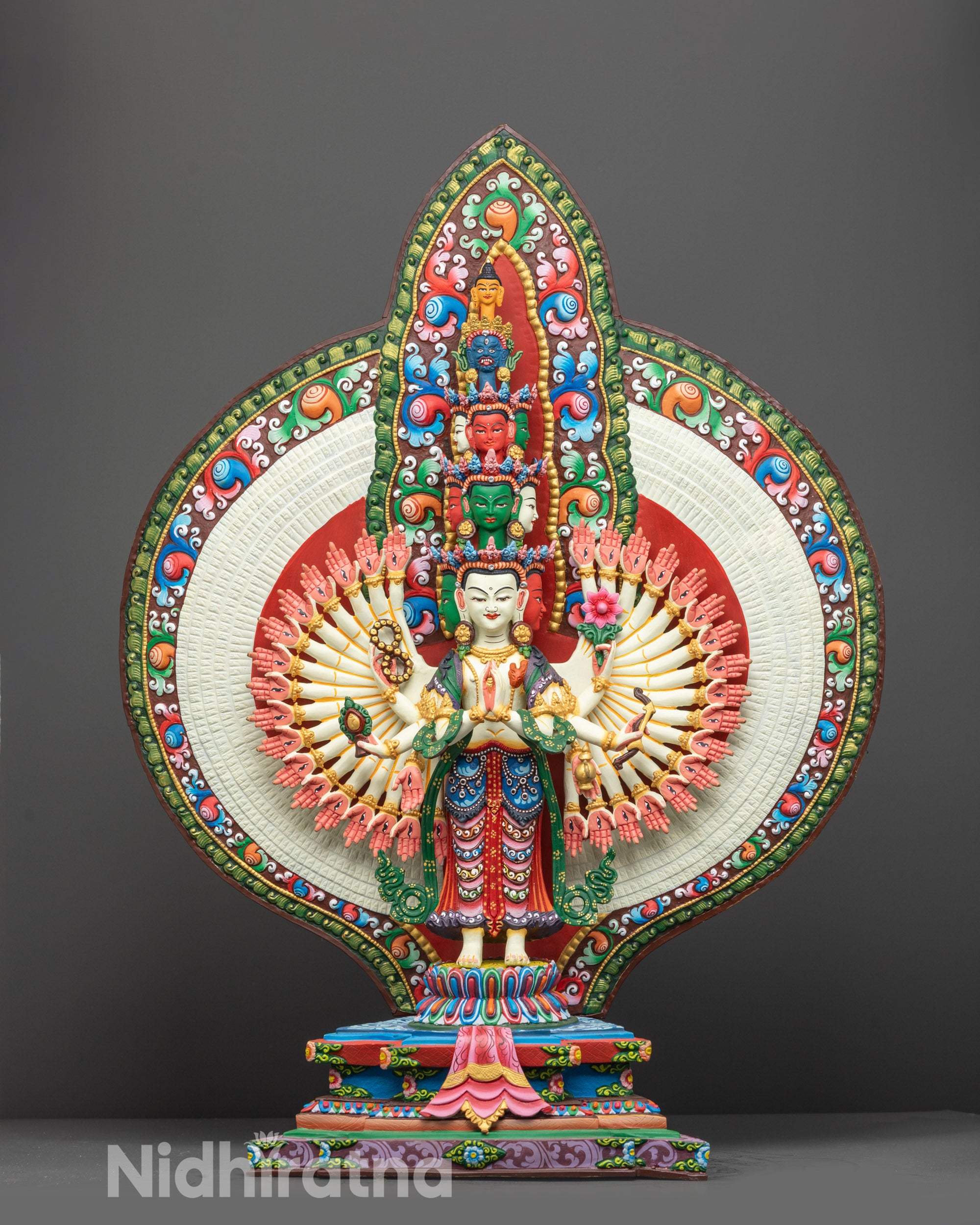Front view of 1000-Armed Chenrezig Statue showing intricate carvings and eleven colorful faces