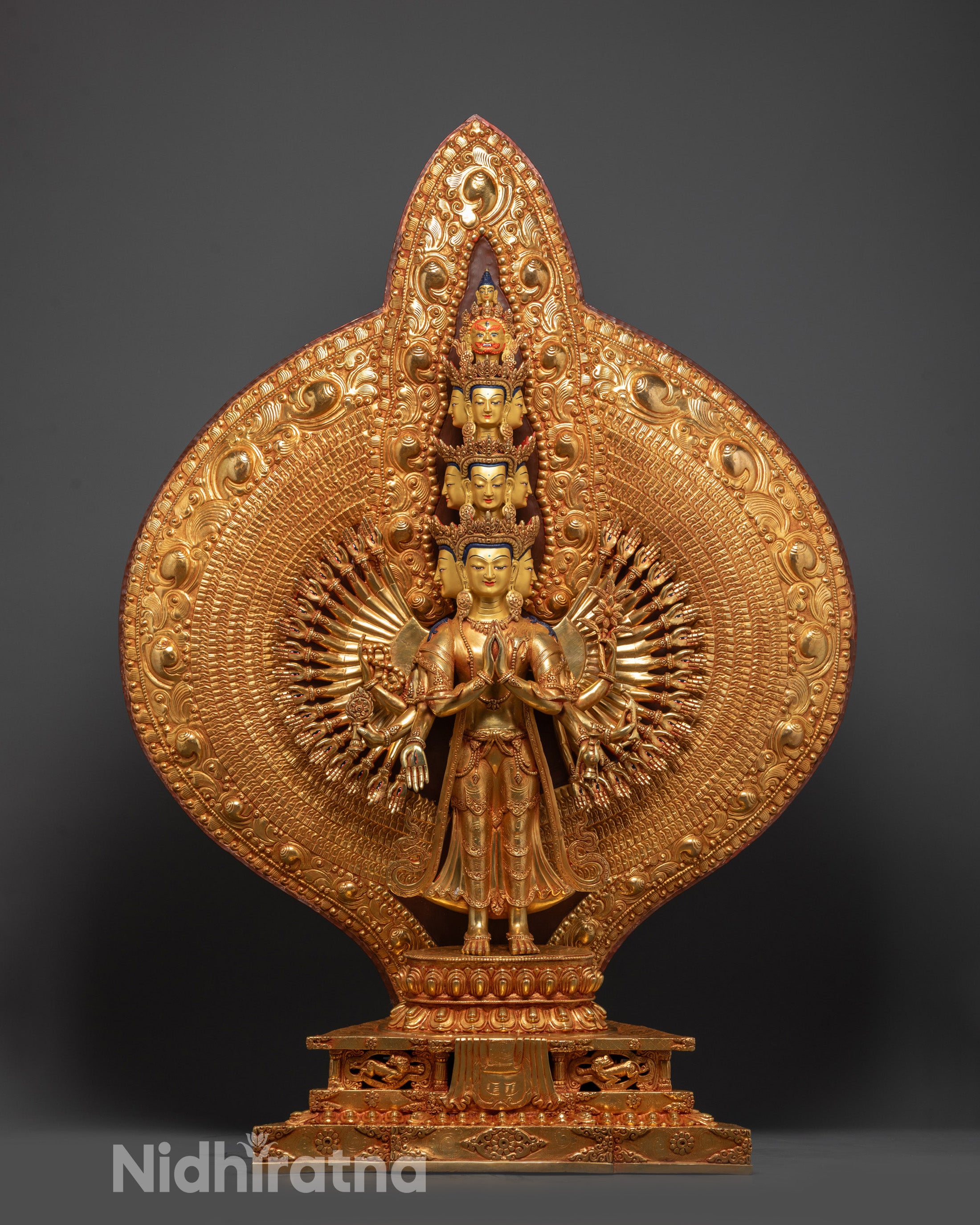 Front view of 1000-Armed Guan Yin Sculpture with gold-gilded face and copper body