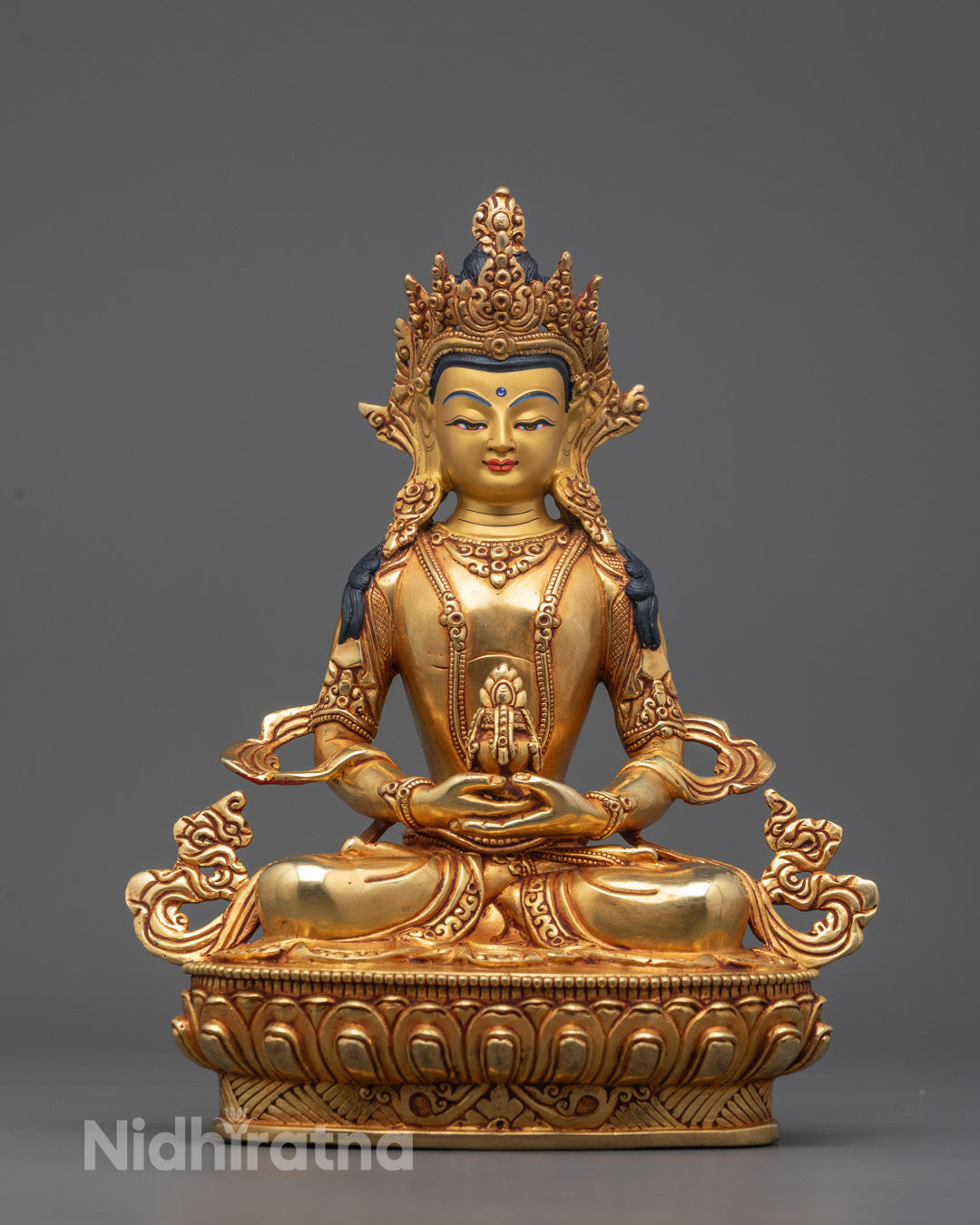Front view of Amitayus statue with gold gilded face and detailed lotus base