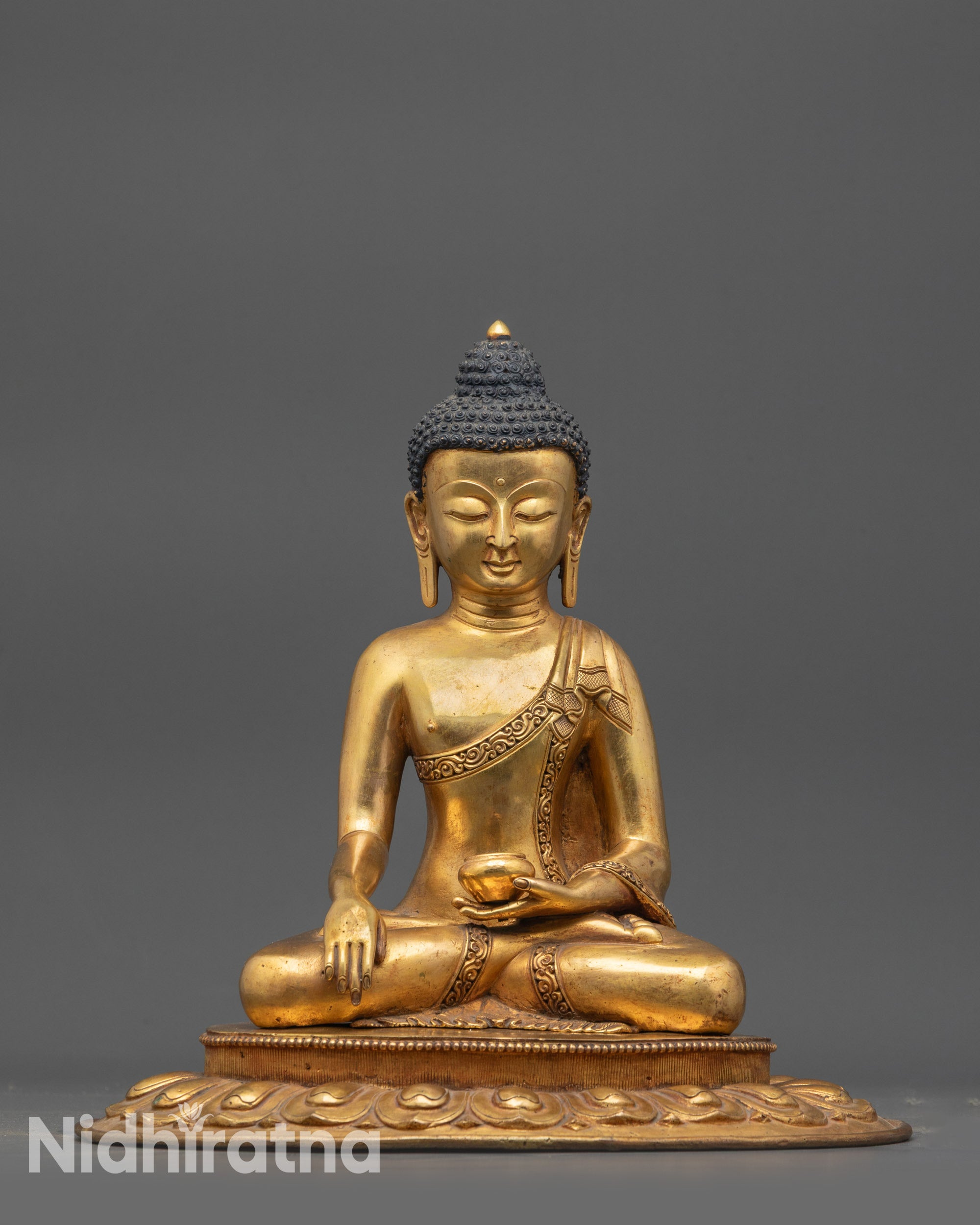 Front view of Antique Shakyamuni Buddha Statue with gold-gilded face and copper base