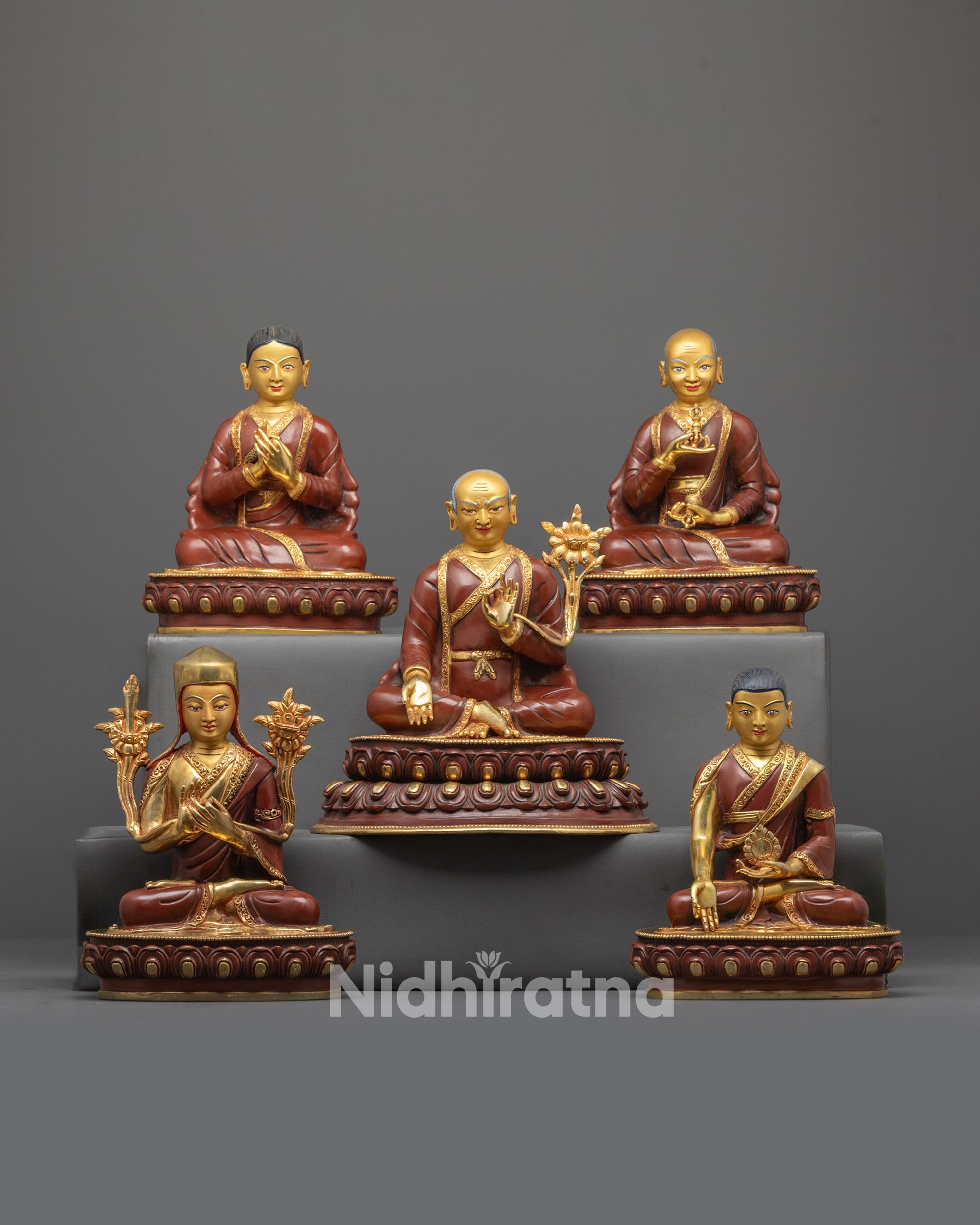 Front view of Artisan-Crafted Sakya Masters Set with gold-gilded faces and lama robes