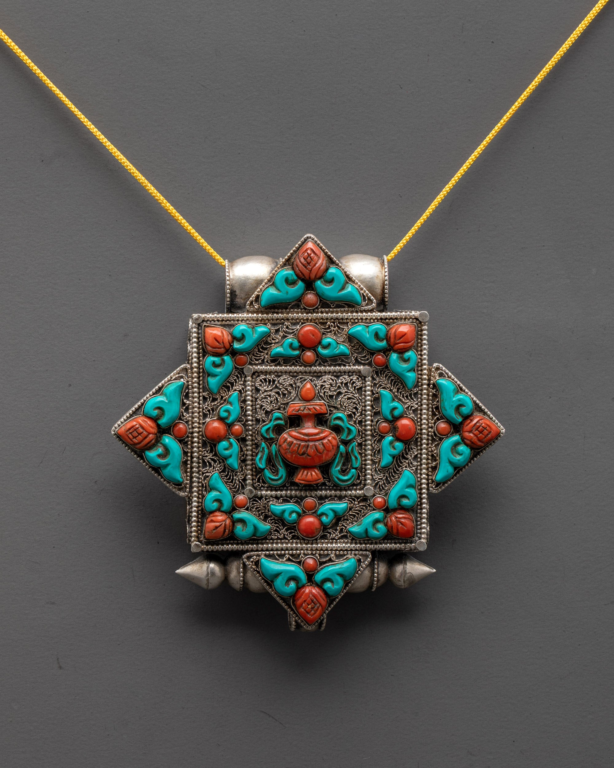Front view of Artisan-Crafted Treasure Vase Locket with silver body and coral turquoise stones