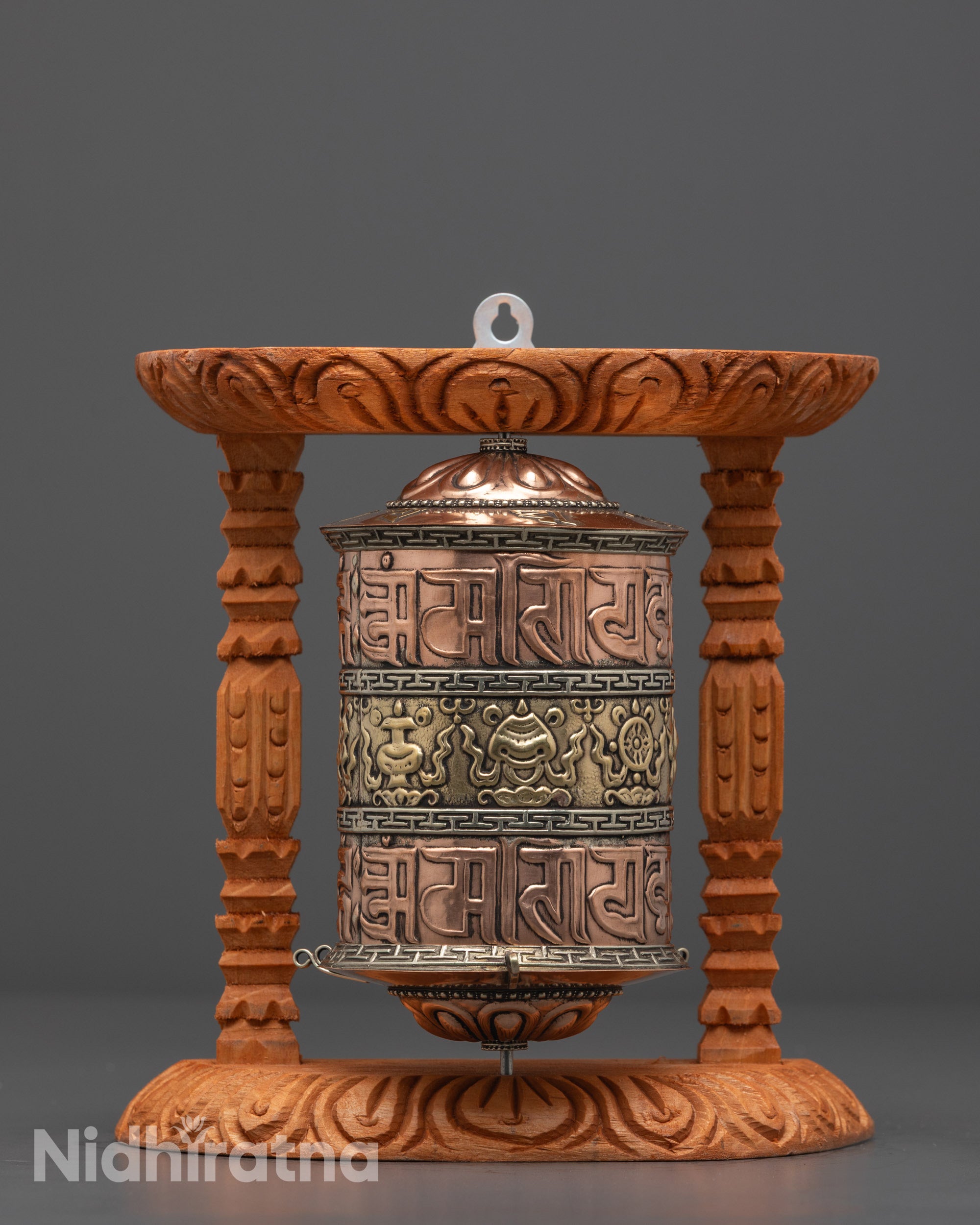 Front view of Auspicious Prayer Wheel showing intricate mantras on copper base
