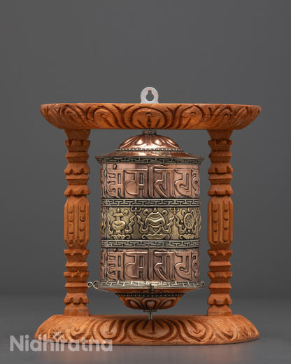 Front view of Auspicious Prayer Wheel showing intricate mantras on copper base
