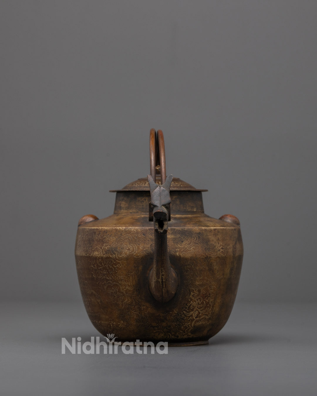 Front view of Authentic Buddhist Tea Pot with deity carvings in brass and bronze