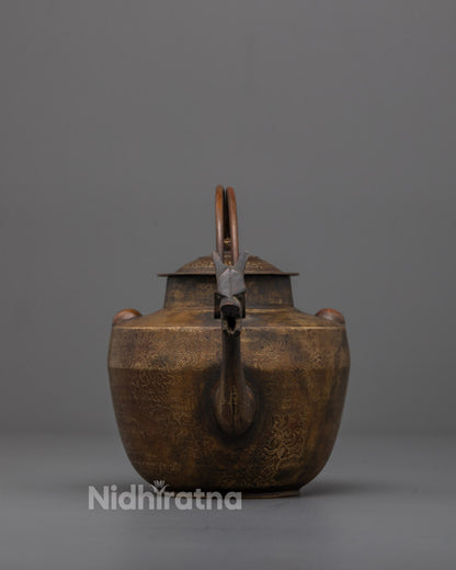 Front view of Authentic Buddhist Tea Pot with deity carvings in brass and bronze
