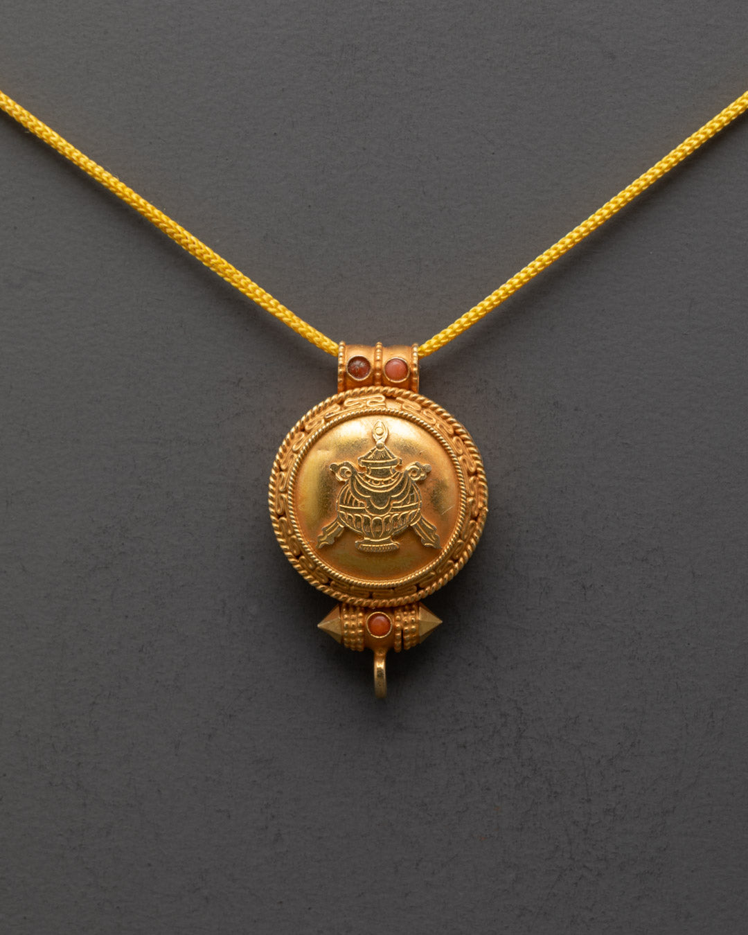 Front view of Authentic Bumpa Tibetan Locket with gold gilding and semi-precious stones