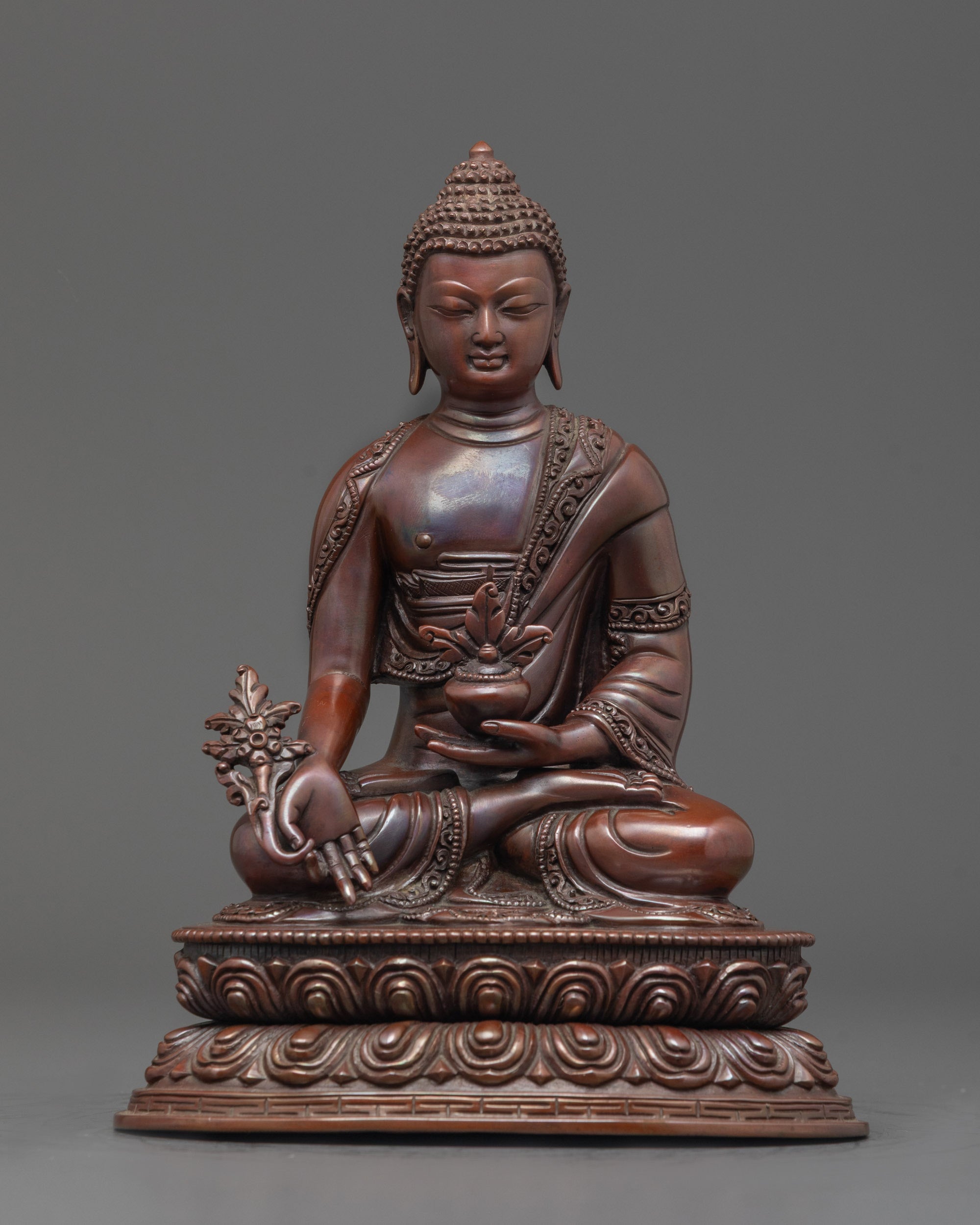 Front view of Bhaisajyaguru Oxidized Healing Buddha Statue with monk’s bowl and robe

