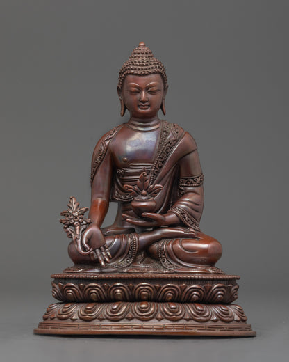 Front view of Bhaisajyaguru Oxidized Healing Buddha Statue with monk’s bowl and robe

