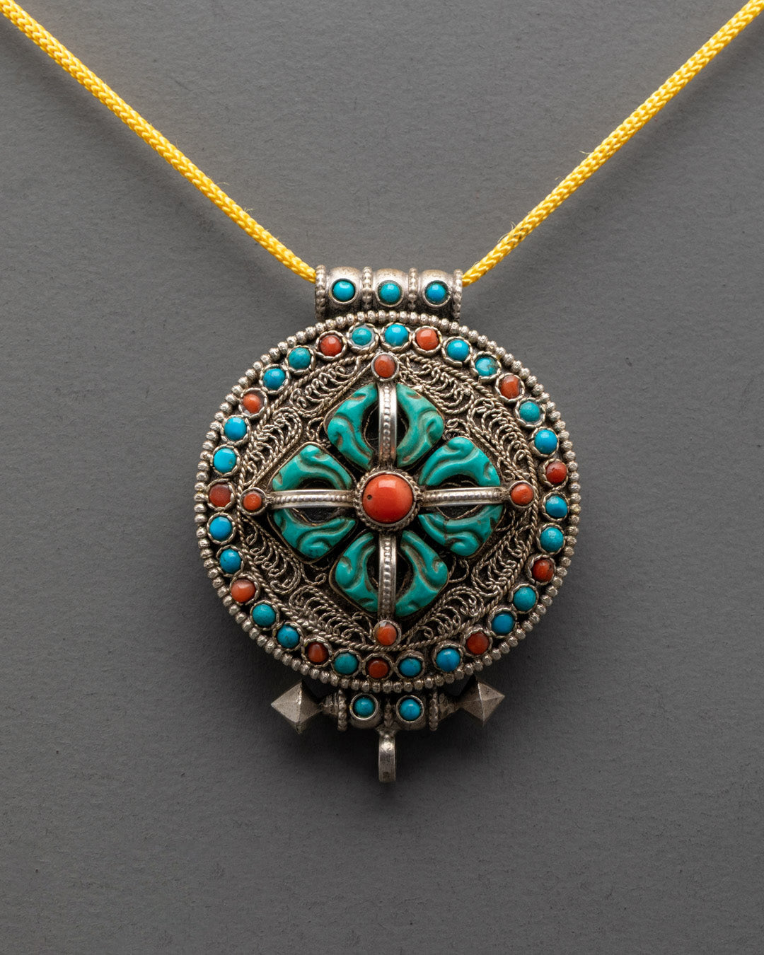 Front view of Bishwo Vajra Locket with turquoise, coral, lapis on silver filigree body